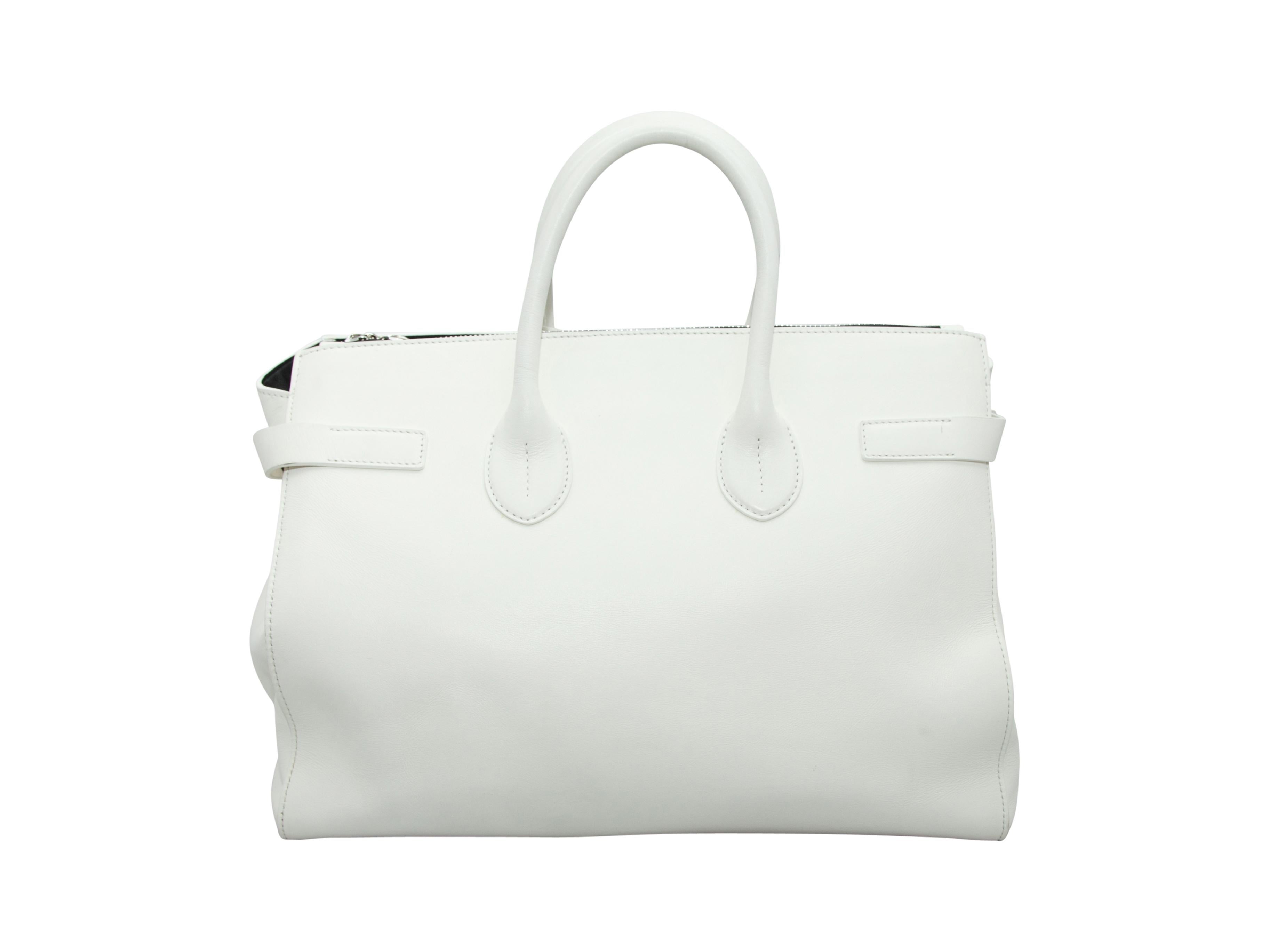 Product details:  White leather tote bag by Calvin Klein 205W39NYC.  Dual carry handles.  Open top.  On-seam zip pocket.  Lined interior with inner slide pocket.  Silvertone hardware.  Dust bag included.  13.5