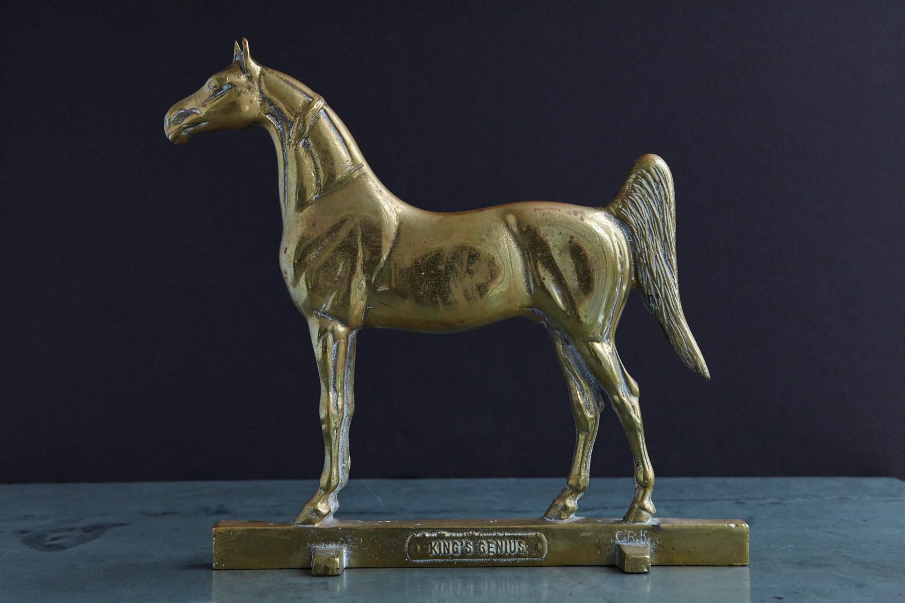 Heavy brass doorstop of King's Genius, one of the greatest racehorses of all time. 
The doorstop was sculptured by Calvin Roy Kinsler and signed with his initials on the lower right.
The manufacturer's name Rife-Loth Corp, Waynesboro, VA is