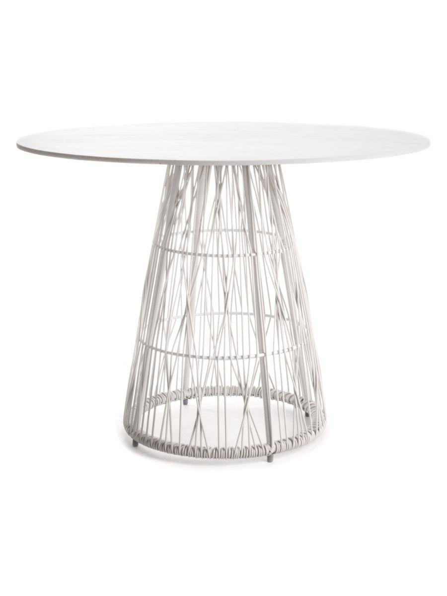 Calyx dining table by Kenneth Cobonpue
Materials: Polyethelene, Steel. Stonecast. 
Dimensions: diameter 100 cm x height 74cm 

Like the lustrous diamond, Calyx features a matrix of interwoven polyethylene strands and a wide crown, making any