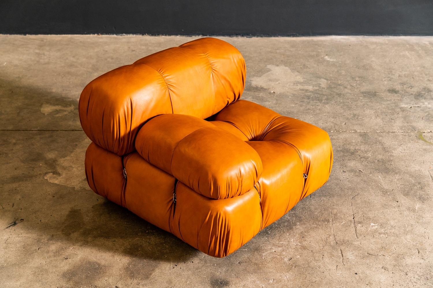 The Camaleonda modular sofa was designed by Italian architect Mario Bellini in 1971.This all original example has four sections. Two single armchairs with 2 accompanying centre chairs. The entire suite retains its original patinated tan leather and