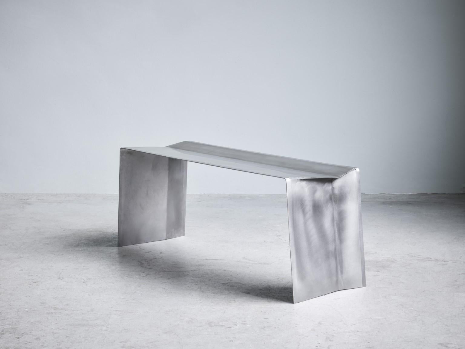 Camber bench, Paul Coenen
Dimensions: W 118 x D 37 x H 45 cm
Materials: Stainless steel

The Camber bench and stool originated from the idea of manufacturing a piece of furniture from a single piece of sheet metal.

The inclining angle of the seat