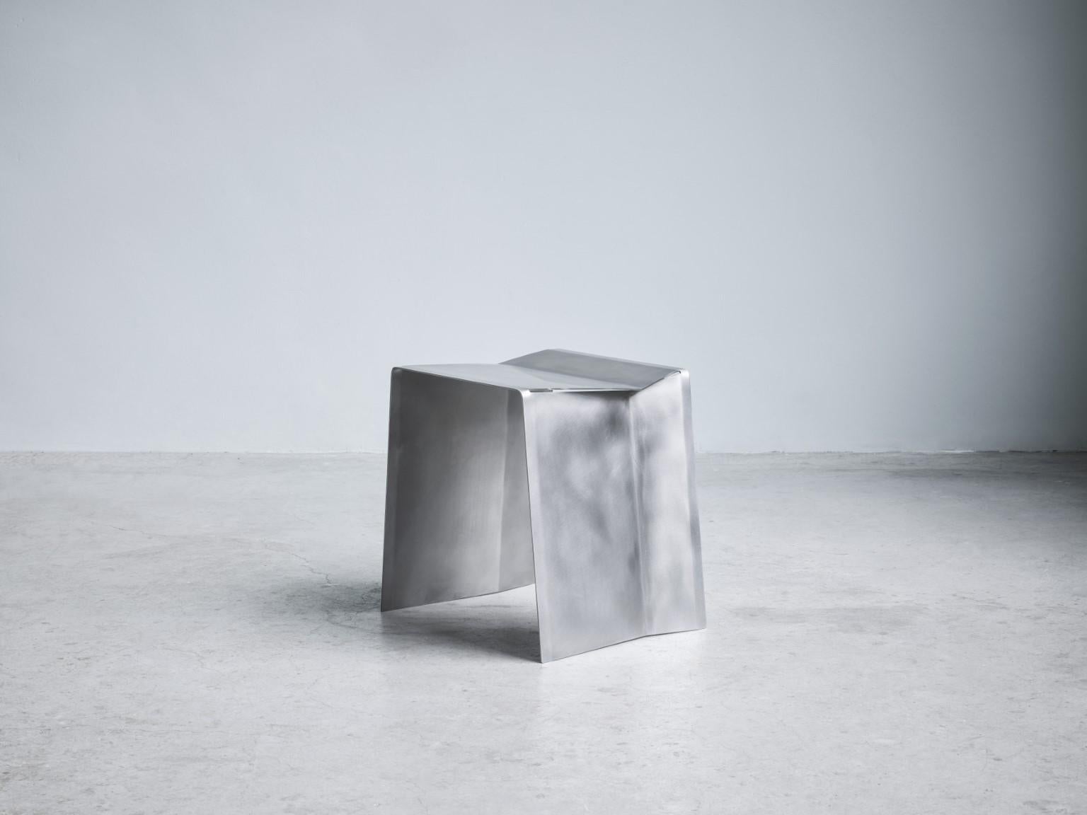 Camber stool, Paul Coenen
Dimensions: W 47 x D 37 x H 45 cm
Materials: Stainless steel

The Camber bench and stool originated from the idea of manufacturing a piece of furniture from a single piece of sheet metal.

The inclining angle of the