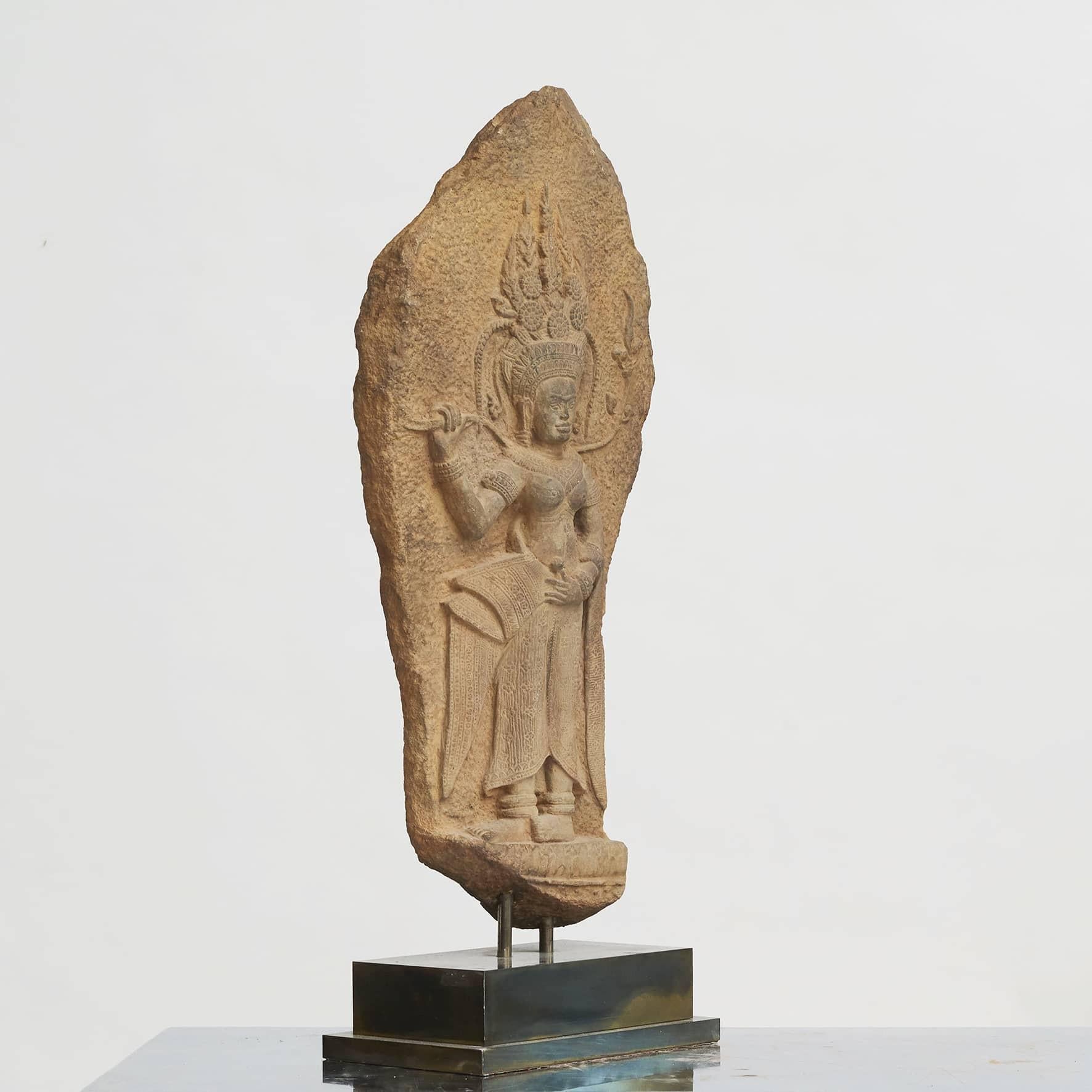 A sandstone carving of female spirit Apsara 'Dancer'. Mounted on custom dark polished brass base. From Angkor Wat, Cambodia.
Bought by the previous owner in 2011. Included was a certificate documenting that the relief is from from the 11th or 12th