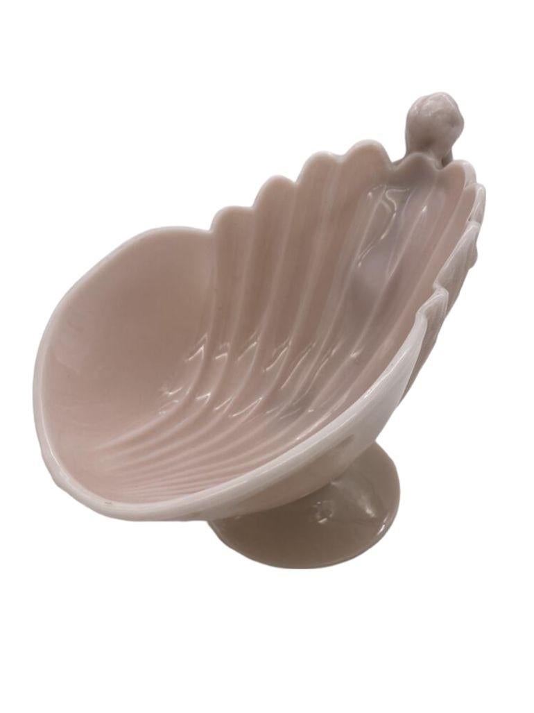This is a beautiful Cambridge art glass bowl. It has a flying nude on the front of a lobed shell design bowl. The art glass is a solid pink color in Cambridge's Crown Tuscan design. This is an elegant design that flows with the position of the nude