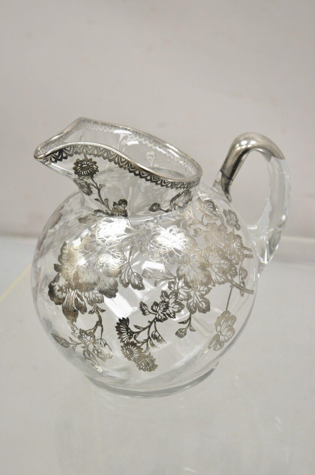 Cambridge Gyro Optic Ball Glass Swirl Water Pitcher w/ Sterling Silver Overlay. Item features swirled blown glass, floral silver overlay, very nice vintage pitcher.. Circa Early to Mid 20th Century. Measurements: 8.5