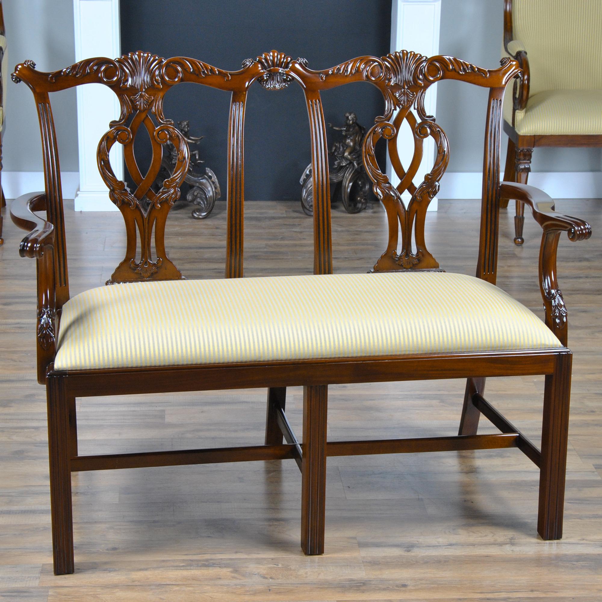 The Cambridge Two Seat Chair is crafted from solid, kiln dried, plantation grown mahogany, hand carved in the Chippendale Style. This classic styled love seat features a serpentine crest rail and a carved and pierced back splat. Scrolled arms at a