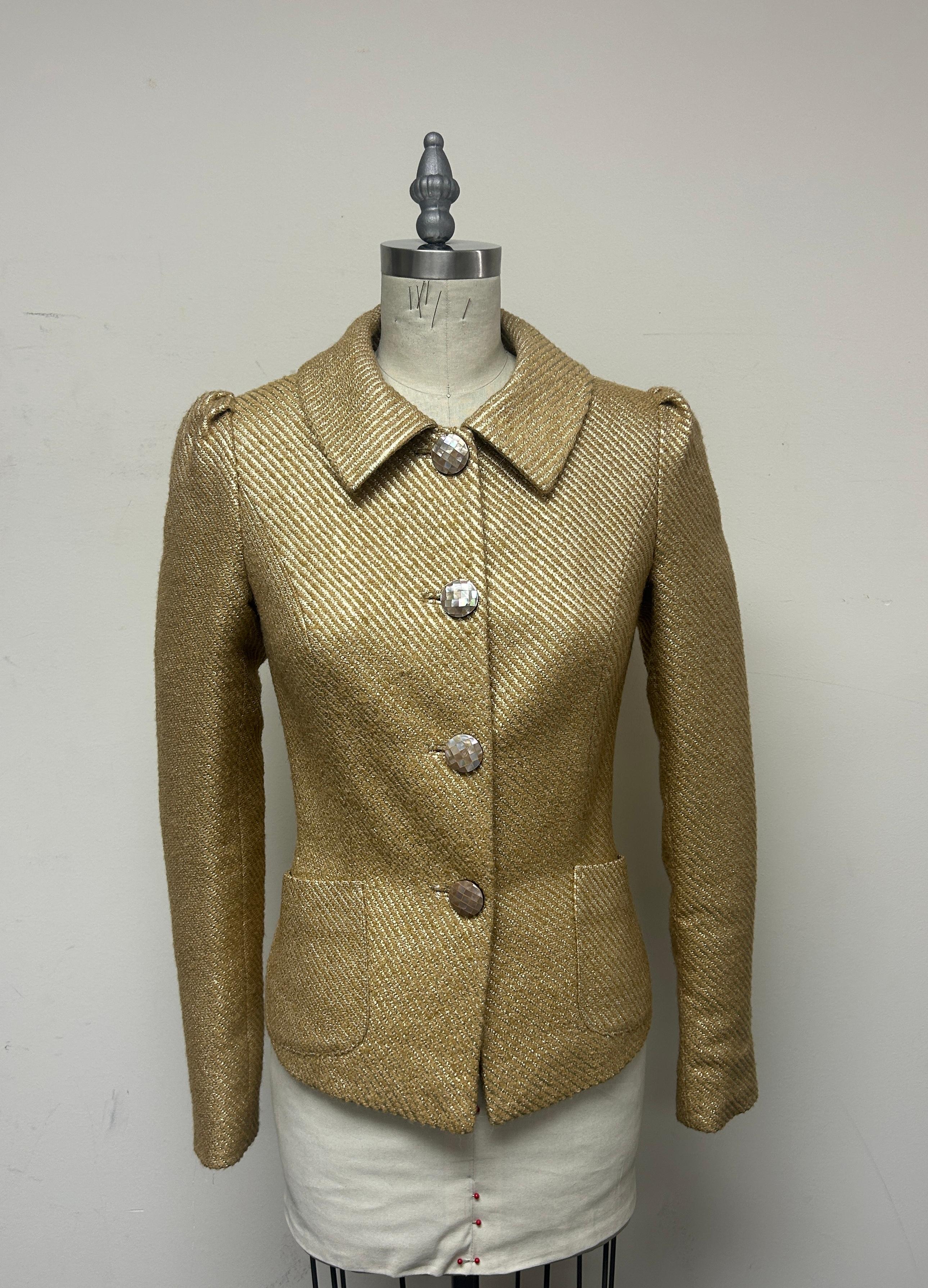 This beautifully fitted jacket is incredibly flattering. A chic jacket in fancy French brocade in camel and gold. Snuggly fitted and secured with mosaic buttons. It is also fully lined in silk for ease and comfort. The round collar and gather at the