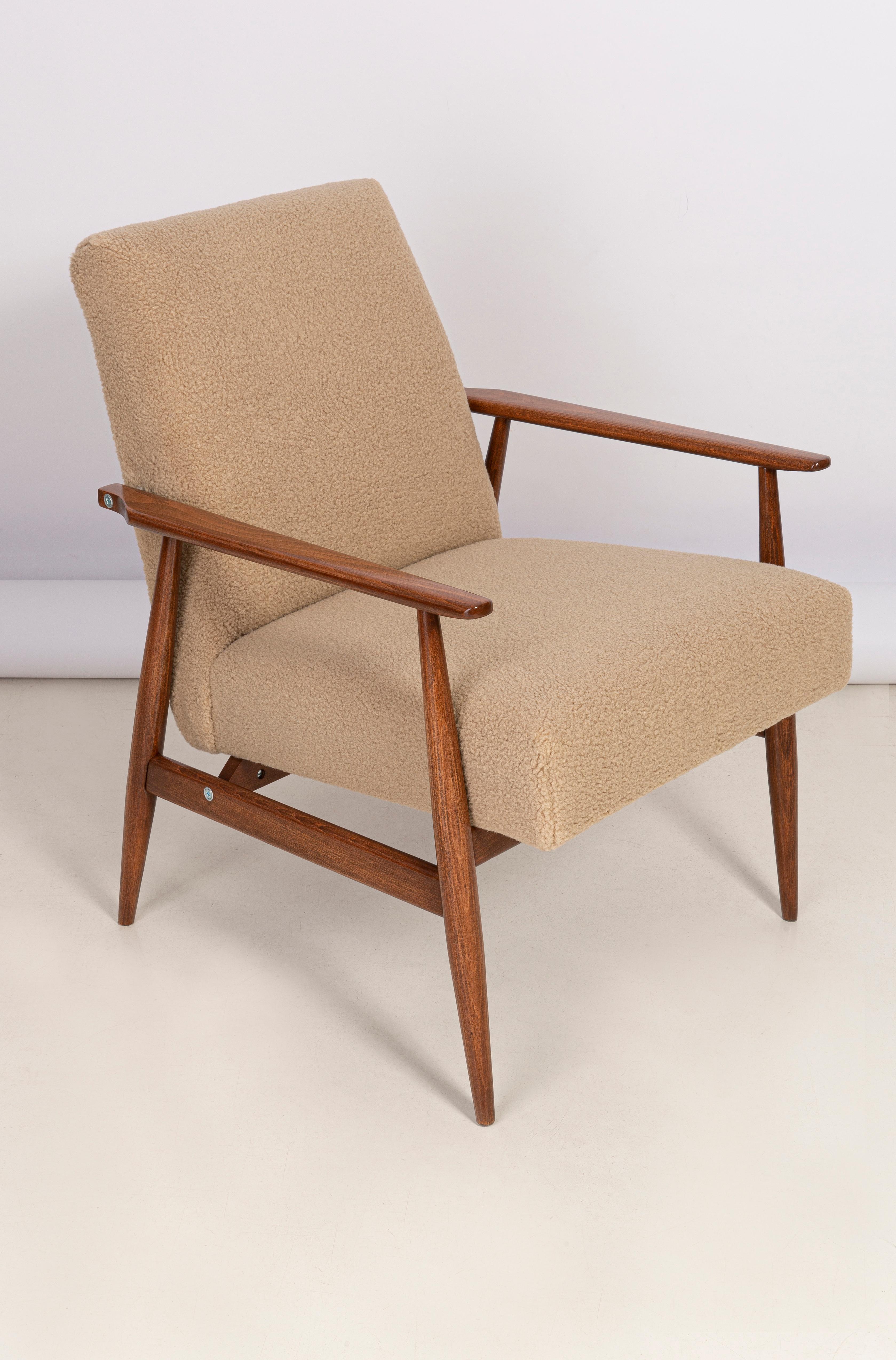 Camel bouclé armchair, designed by Henryk Lis. Furniture after full carpentry and upholstery renovation. The armchair will be perfect in Minimalist spaces, both private and public. 

Upholstery, faux fur has a structure reminiscent of a dense,