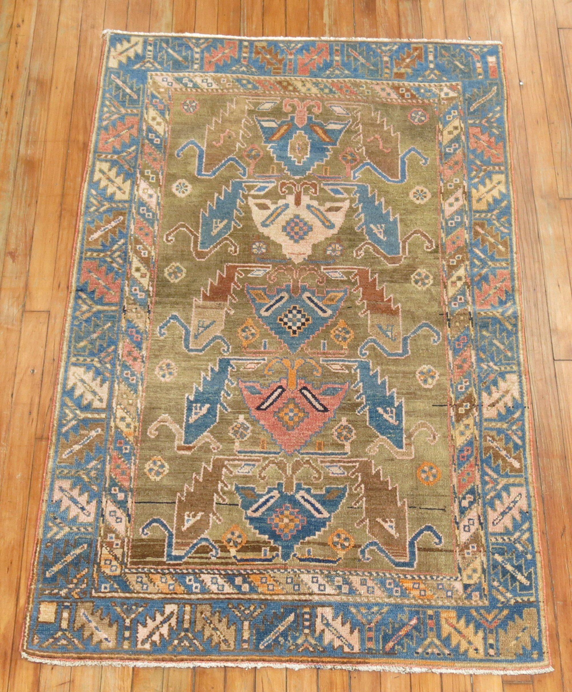 A fine example of camel field Caucasian Rug. Shades of denim blue and orange sprinkled in