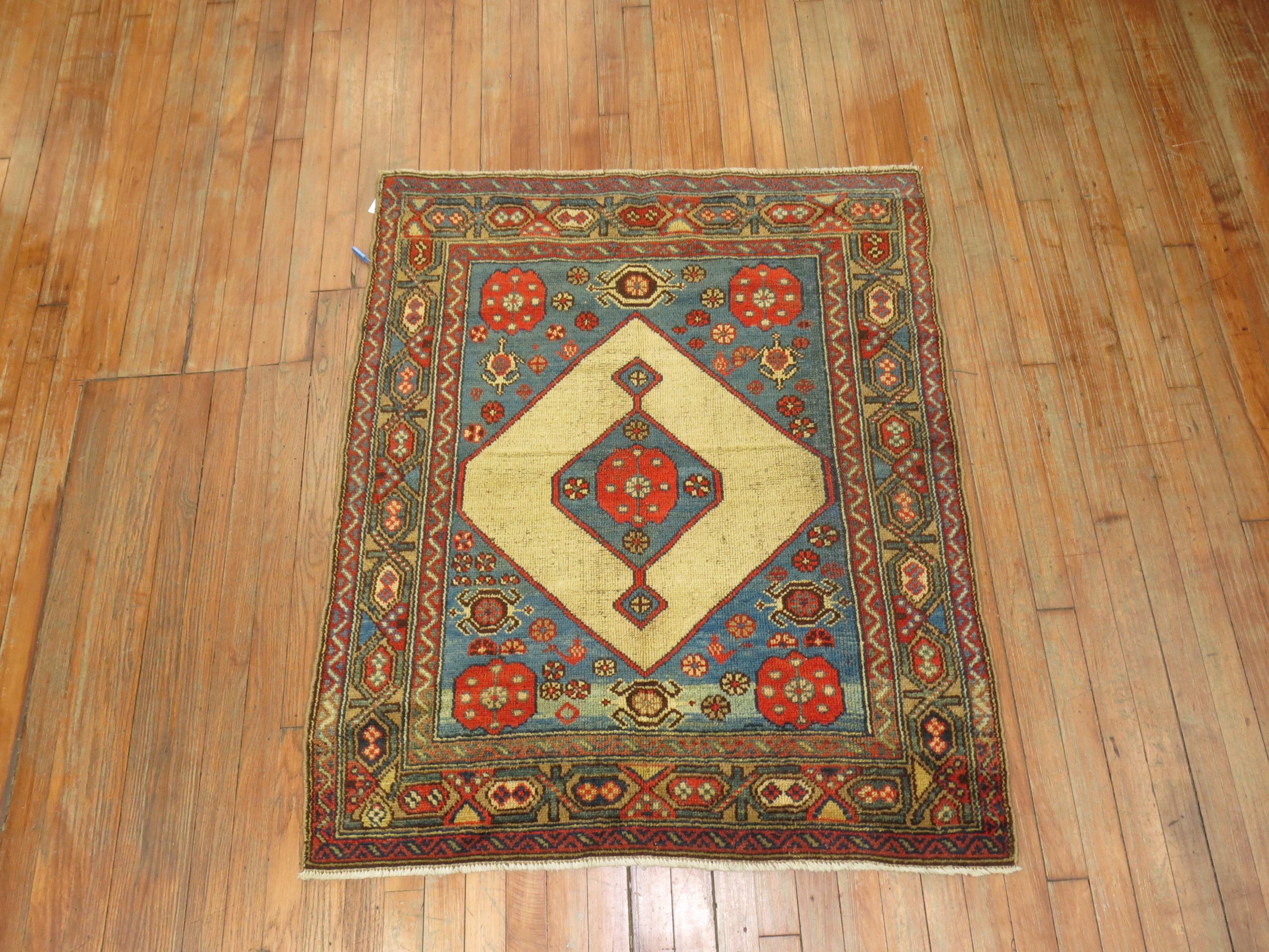 An early 20th century Persian Serab mat. Light blues, coral, on a camel field. Measures: 3'4