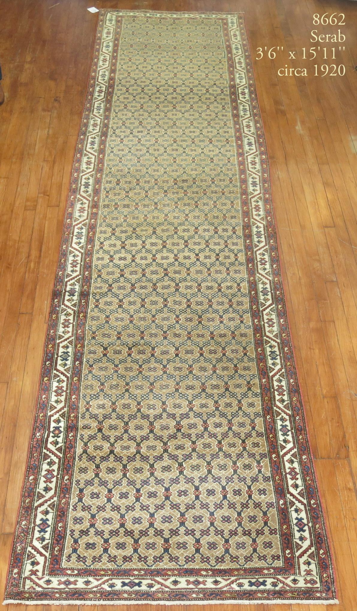 An authentic early 20th century Persian Serab runner with a small all-over geometric design predominantly in camel and blue.

Measures: 3'6'' x 15'11''.