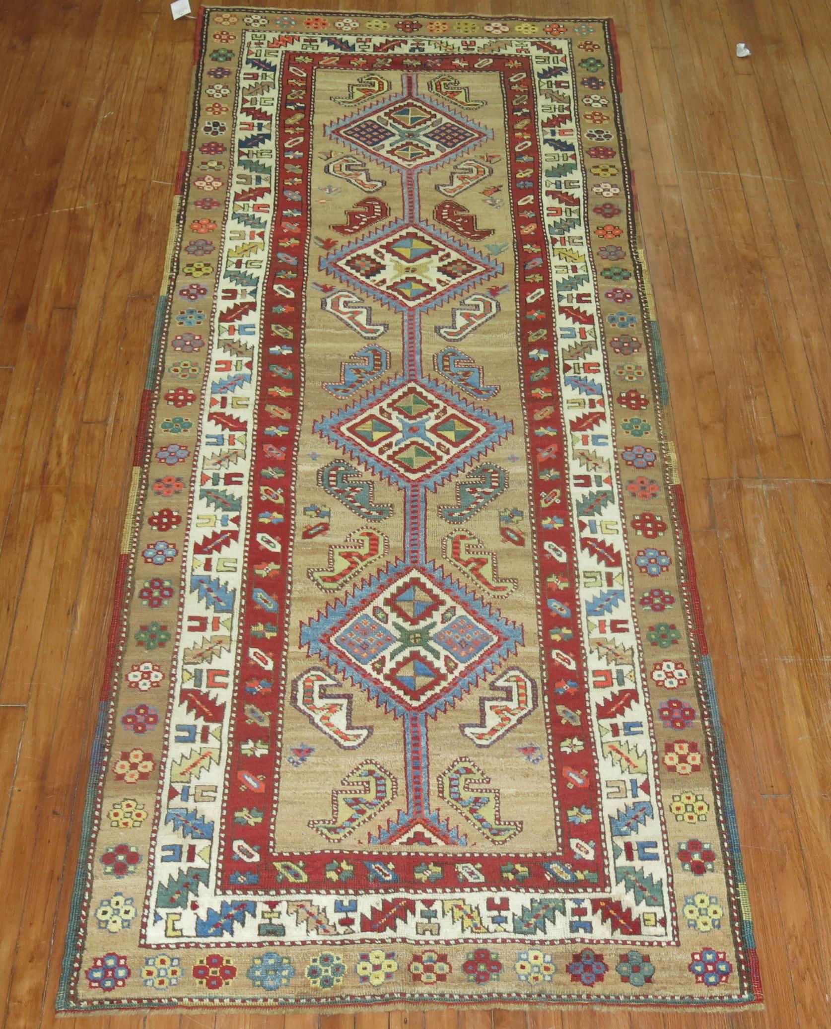 An authentic early 20th century Persian Serab runner with 4 colorful geometric medallions on a camel field and multi-band border in red, ivory and camel. Pops of orange and green are found elsewhere. These runners are usually found narrower in