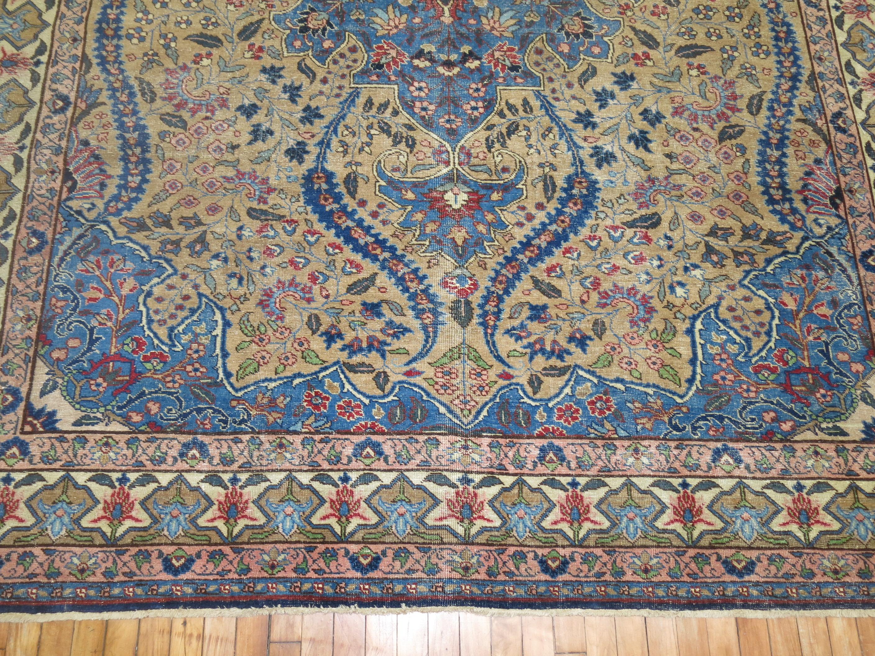 Feminine room size Vintage Persian Tabriz with predominant royal blue accents, with soft pink highlights and camel field. Measures: 8'4'' x 11'2''.