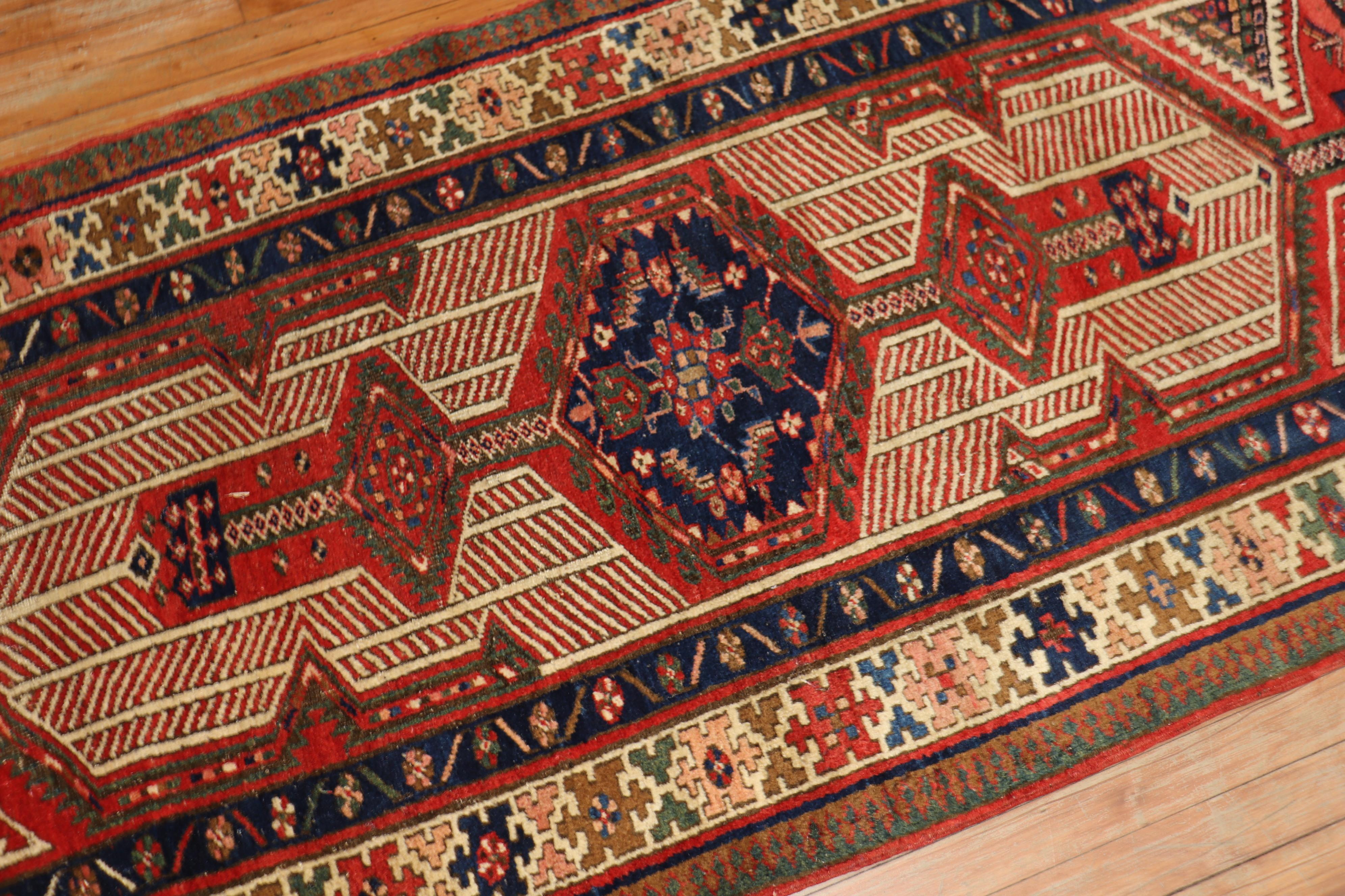 A 20th century tribal highly decorative Persian Serab wide runner. Great quality and great condition. Accents in blue brown red and green on camel brown tone ground

Measures: 3'4