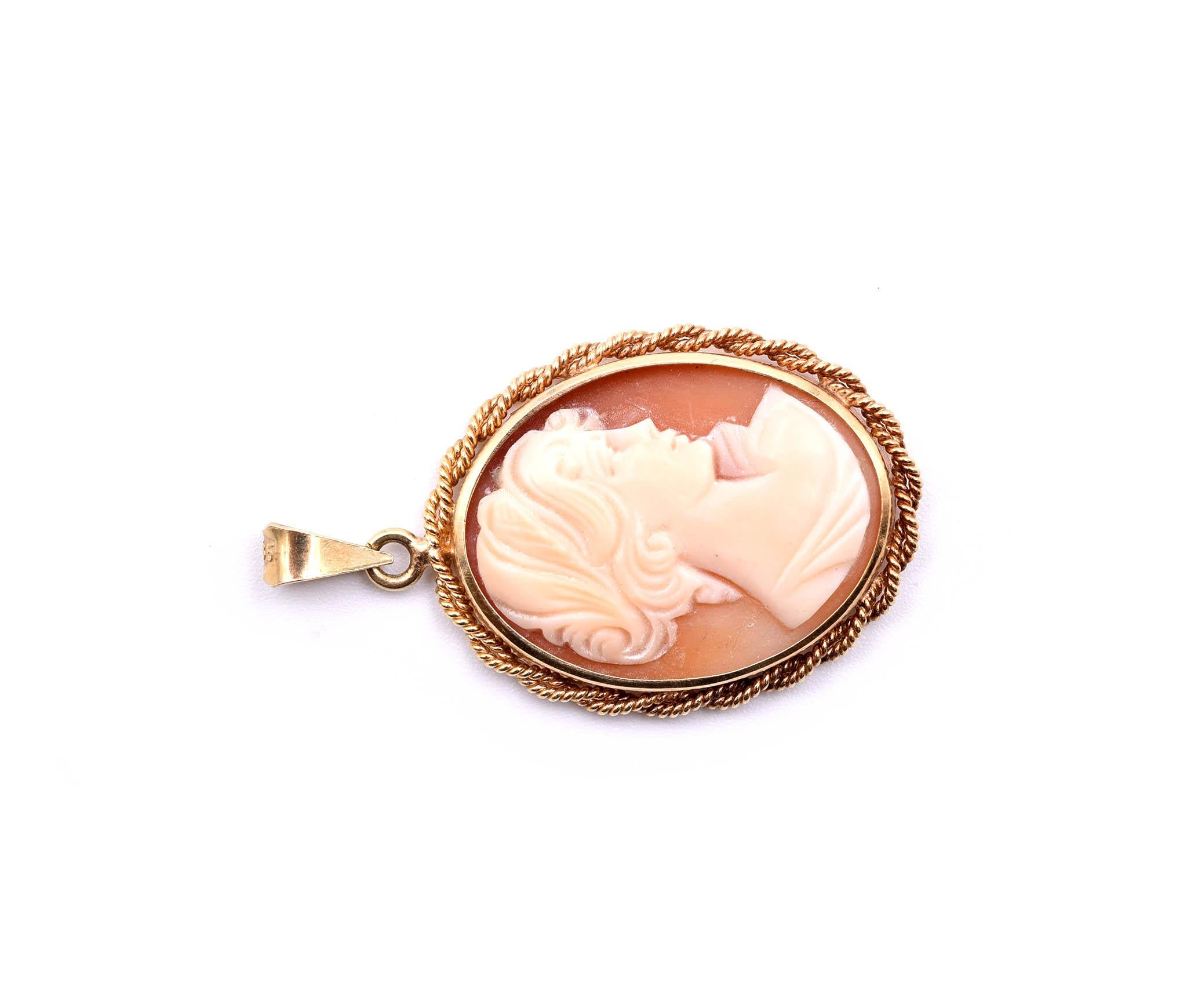 Designer: custom design
Material: 14k yellow gold
Dimensions: pendant is 1 3/8-inch long and 7/8-inch wide
Weight: 5.0 grams
