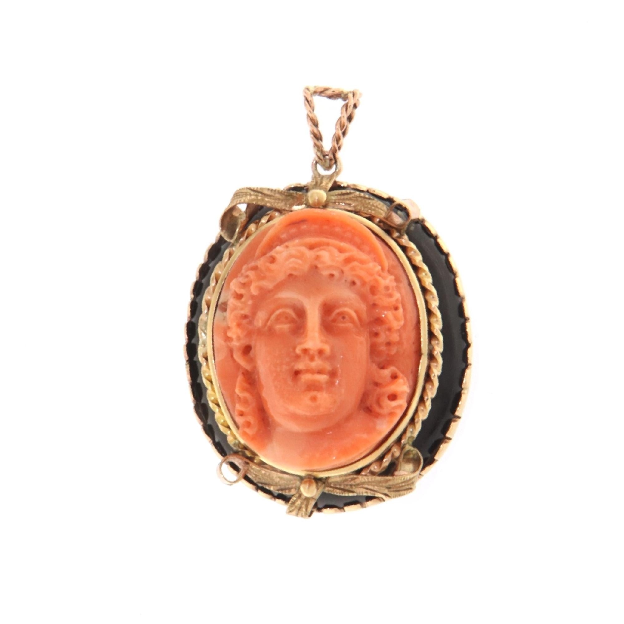 This sophisticated pendant, crafted in 9-karat gold, is a sublime fusion of classic elegance and contemporary design. At the heart of this jewel lies a coral cameo, finely carved to reveal the craftsmanship and artistic depth of its creation. The