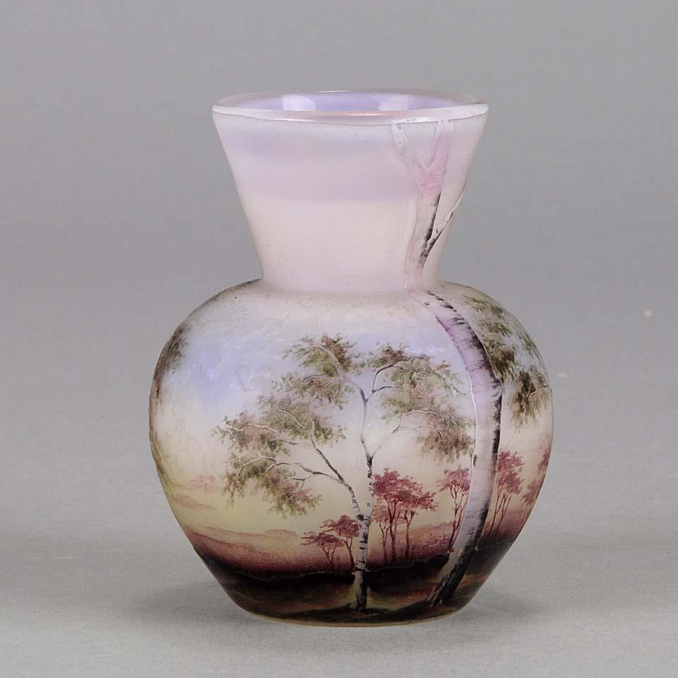 A pretty cabinet cameo glass vase of bulbous form etched and enamelled with a beautiful three dimensional lilac and pink landscape of silver birches against an ethereal background, with excellent colour and super detail, signed Daum Nancy and with