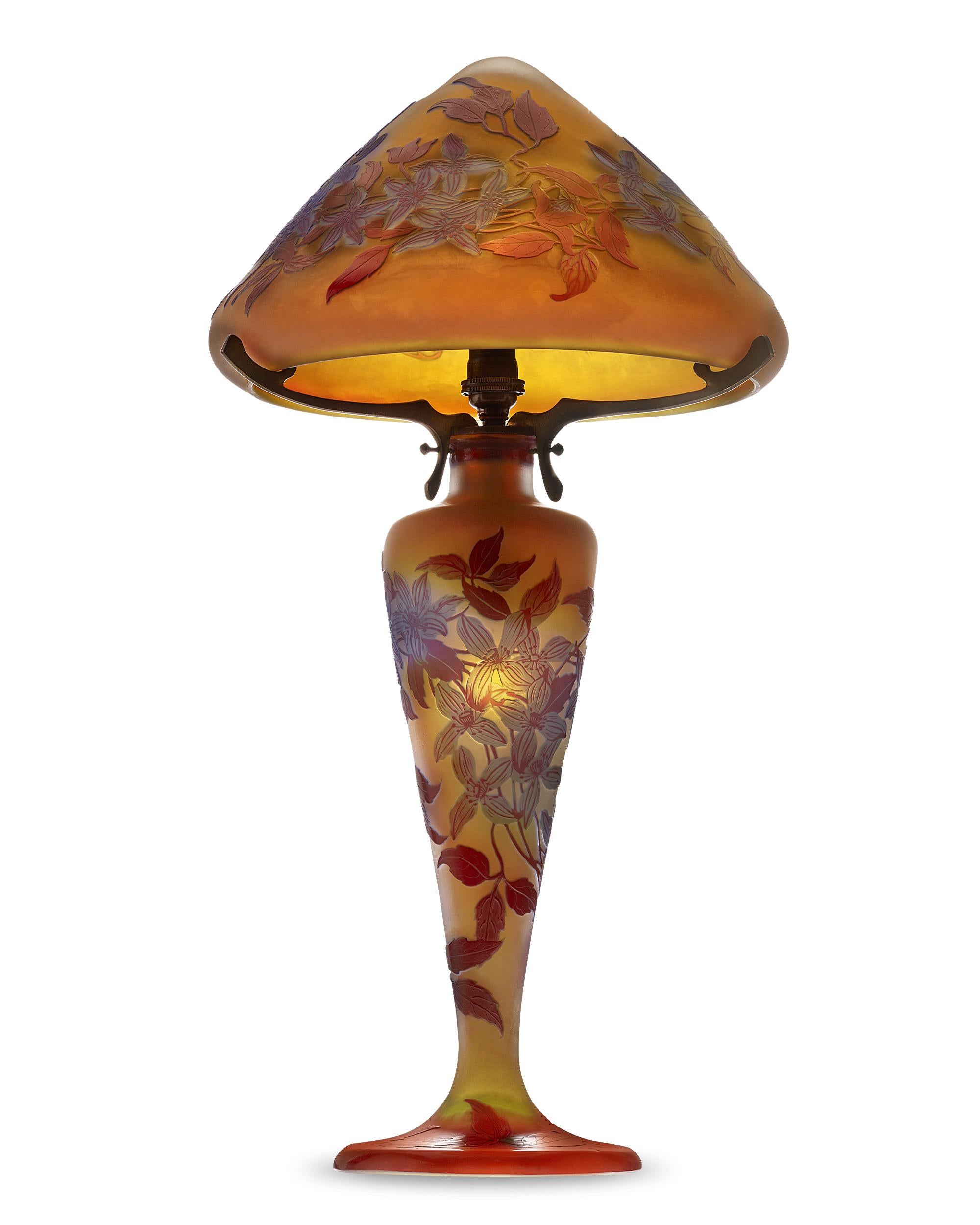 Impressive in both size and artistry, this magnificent lamp is the work of the famed Art Nouveau master Émile Gallé, one of the most highly regarded names in French glassmaking. The artist's appreciation of nature is evident in the detailed