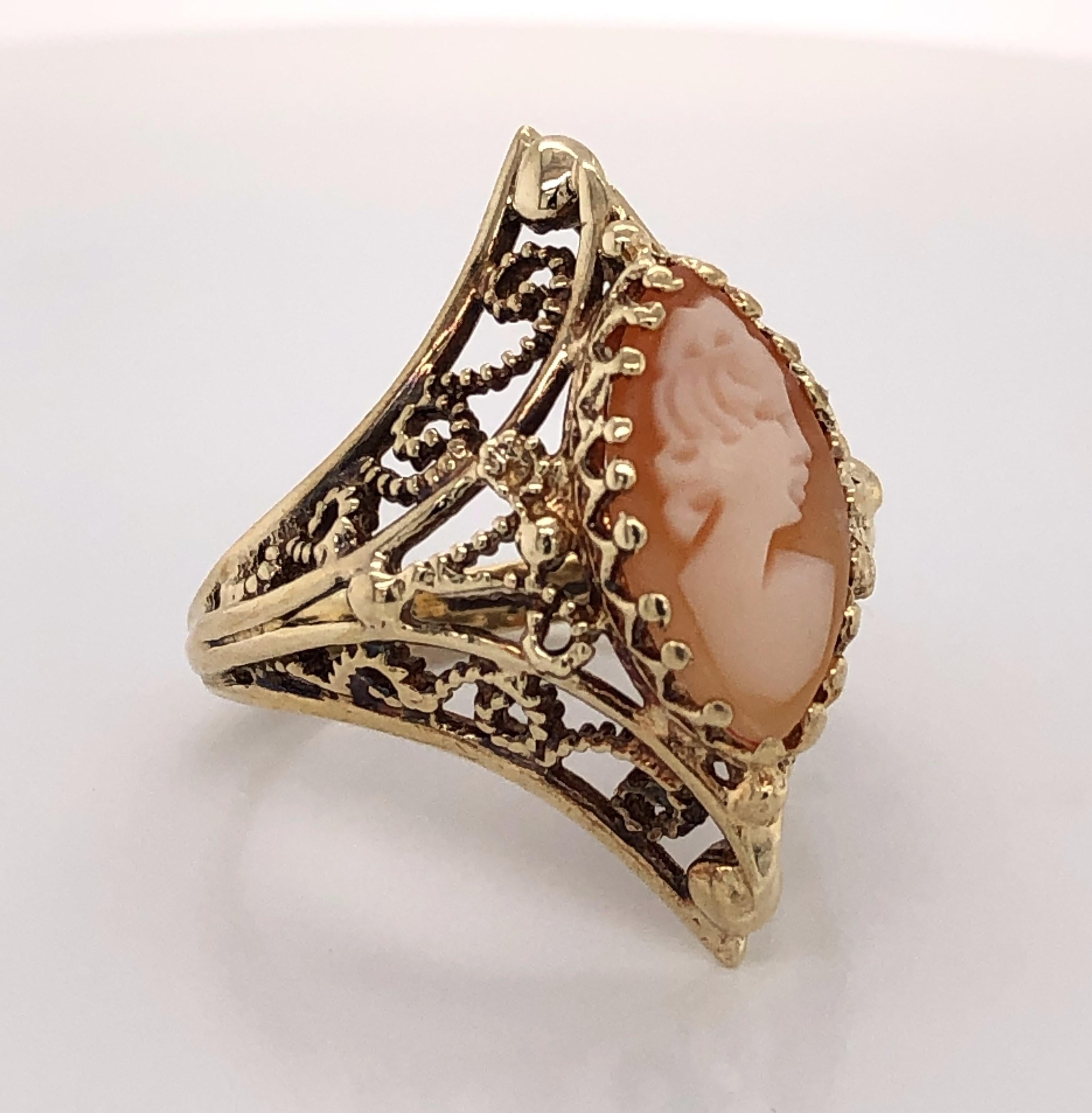Intricate fourteen karat 14K gold filigree beautifully follows the shape of the marquise center and ornately frames the hand carved madam carved in shell in antique-style. Ring size 7.5.  In gift box.