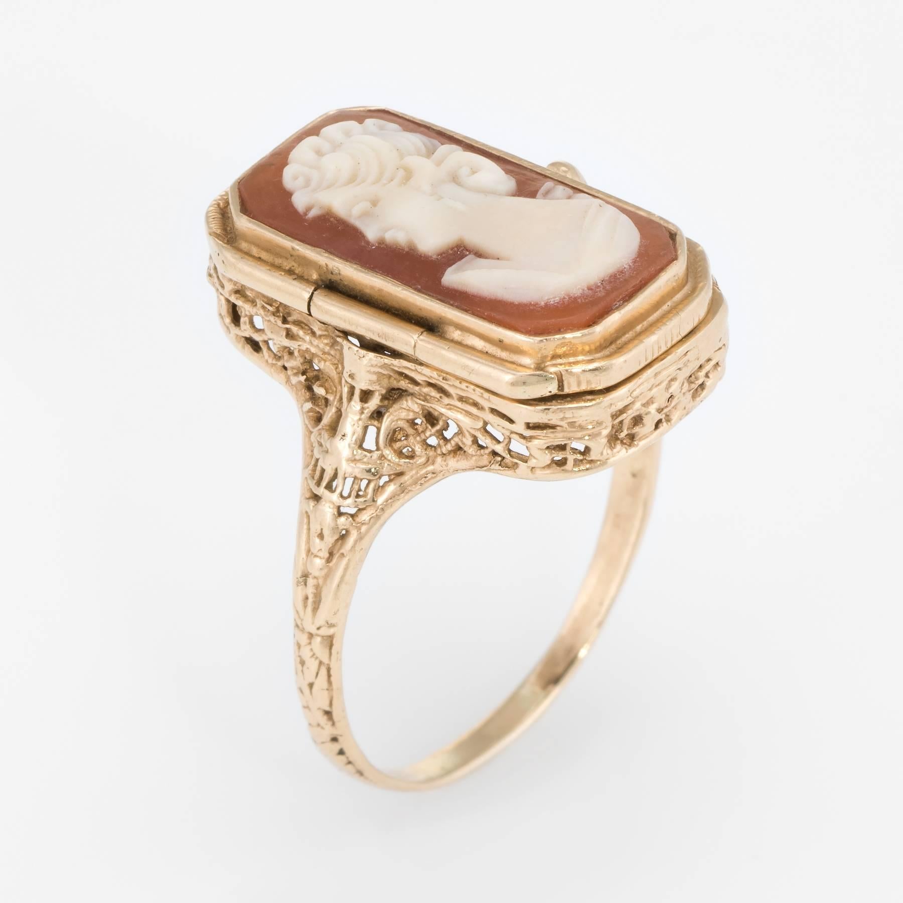 Finely detailed vintage flip cocktail ring, crafted in 14 karat yellow gold. 

Carved shell cameo depicting the side profile of a woman measures 18mm x 10mm. The onyx also measures 18mm x 10mm. The cameo & onyx are in excellent condition and free of