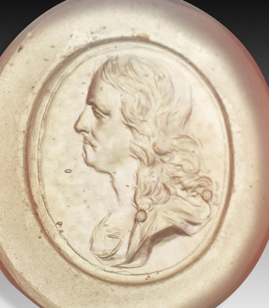  Cameo or intaglio, male portrait. Glass. Possibly Italy, 19th century. 
Male profile with long hair and mustache following a fashion that, for example, can be seen in some portraits of the French king Louis XIII. These types of pieces were created