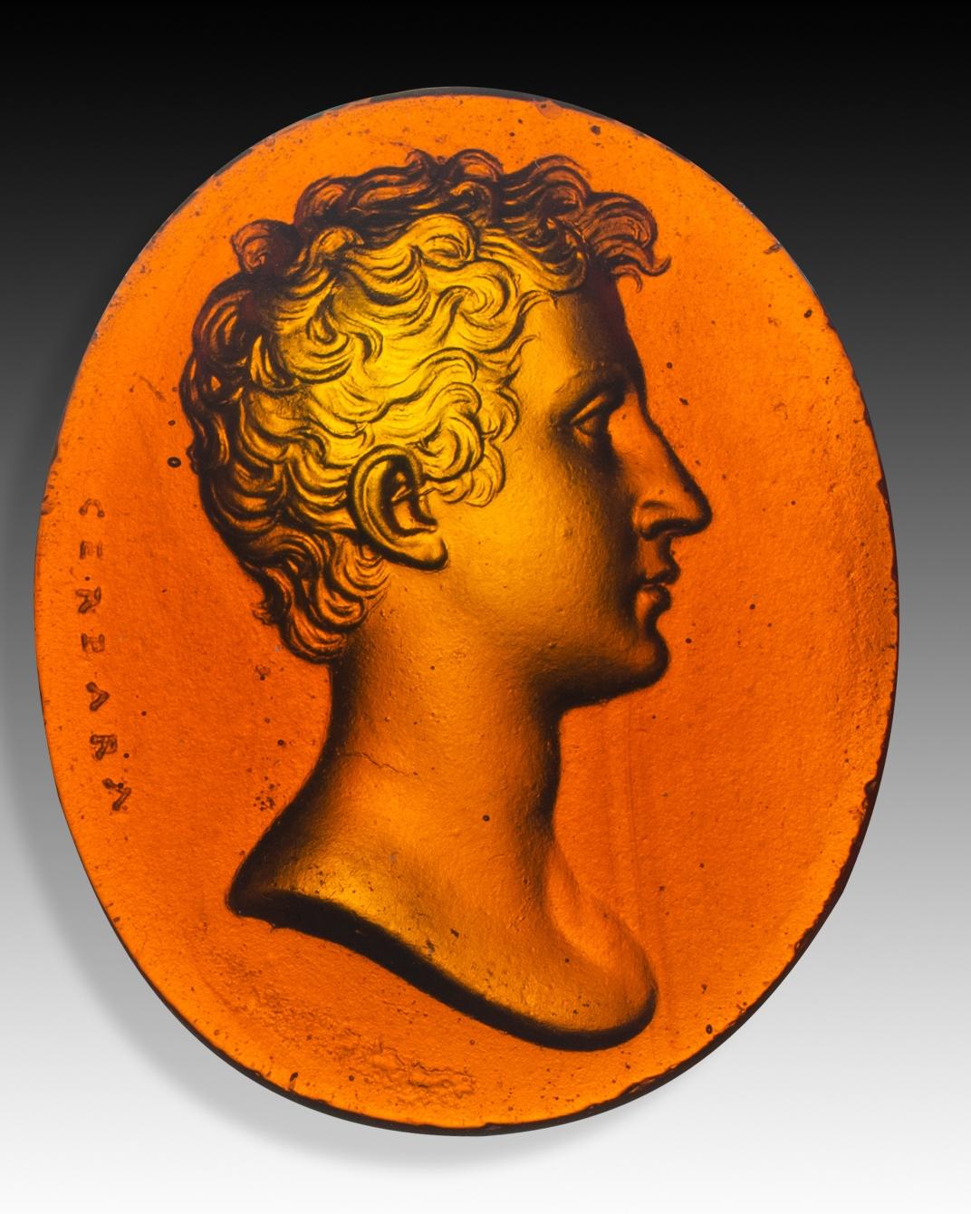 Cameo or intaglio, male profile. Glass. Possibly Italy, 19th century. 
Glass cameo with a male profile in the classical manner accompanied by a pseudo-signature in the Greek alphabet. These types of pieces were created in a significant number as