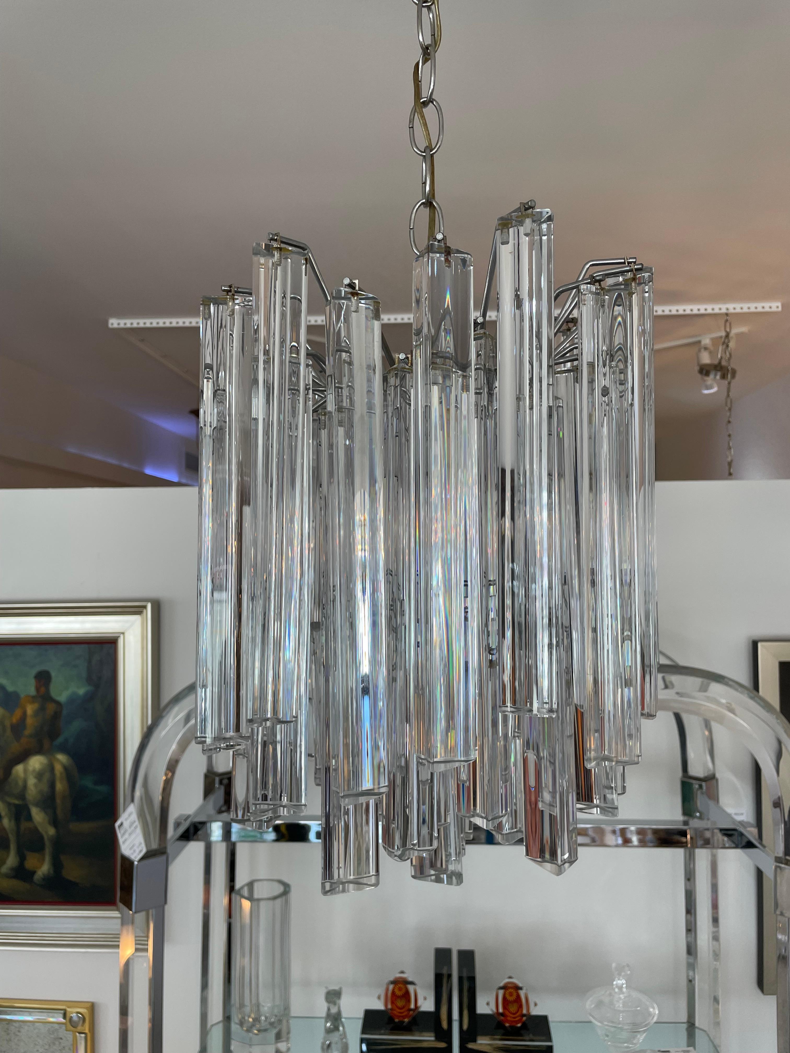 This stylish, chick and classic Camer chandelier dates to the 1960s-1970s, it will make a subtle statement with its form and Venini Murano glass prisms.

Note: Top layer prisms measure 11