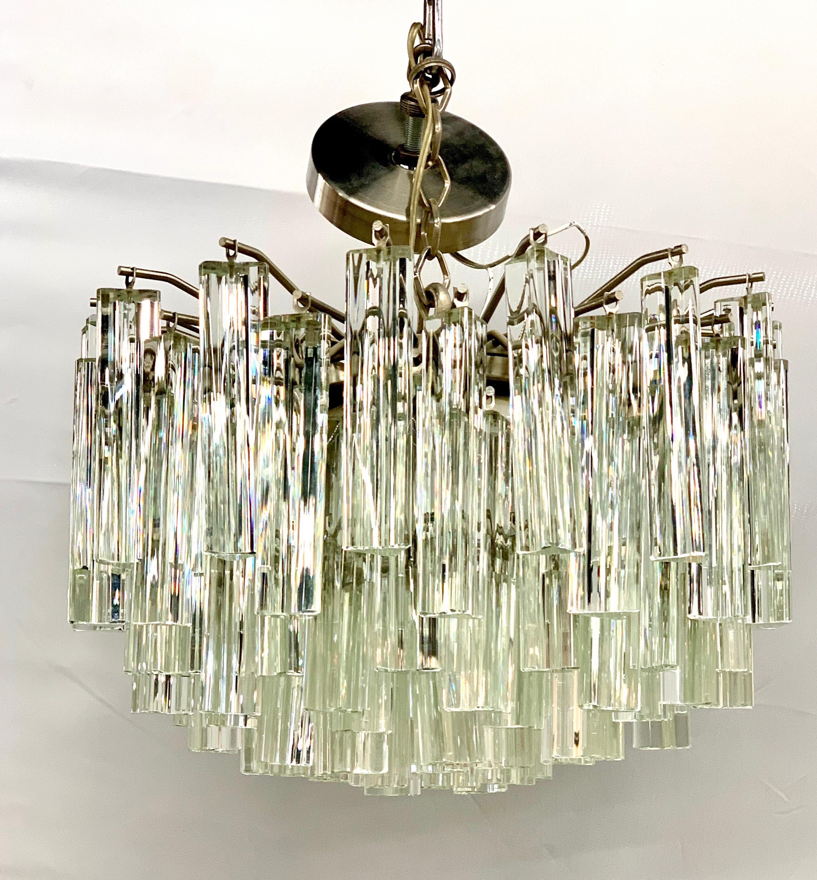 Stunning Camer Glass prism chandelier that features individual prisms that attach to the fixture and that is attached to a steel chain to the ceiling, see pics. Camer glass chandeliers are true period pieces from the 1970s and have been featured in