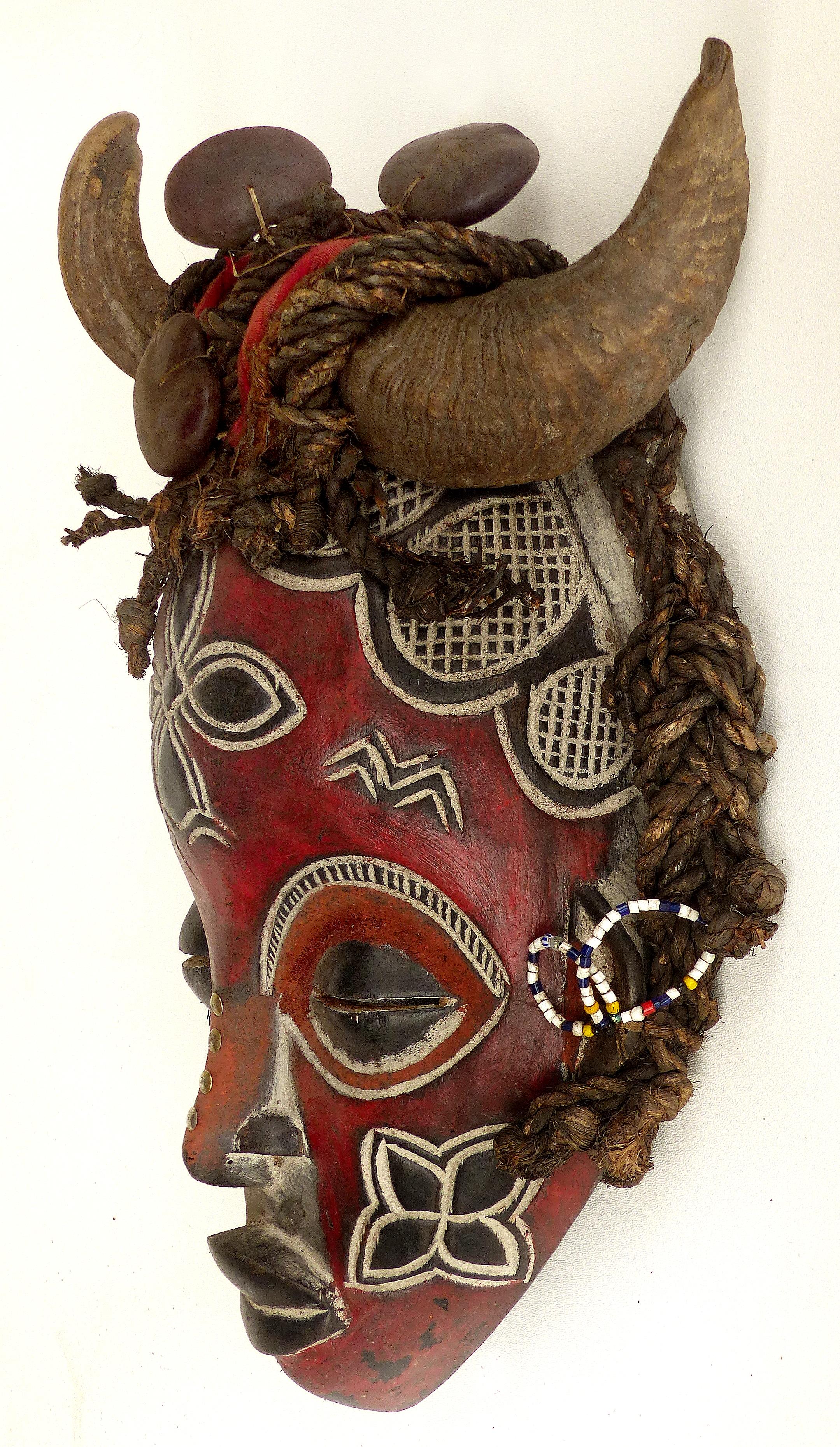 Cameroon Bamileke Tribal Carved Horned Mask Embellished with Sea Beans & Beads

Offered for sale is an interesting carved mask from the Bamileke people of Cameroon, Africa. This interesting and decorative mask is decorated with horns, lucky sea