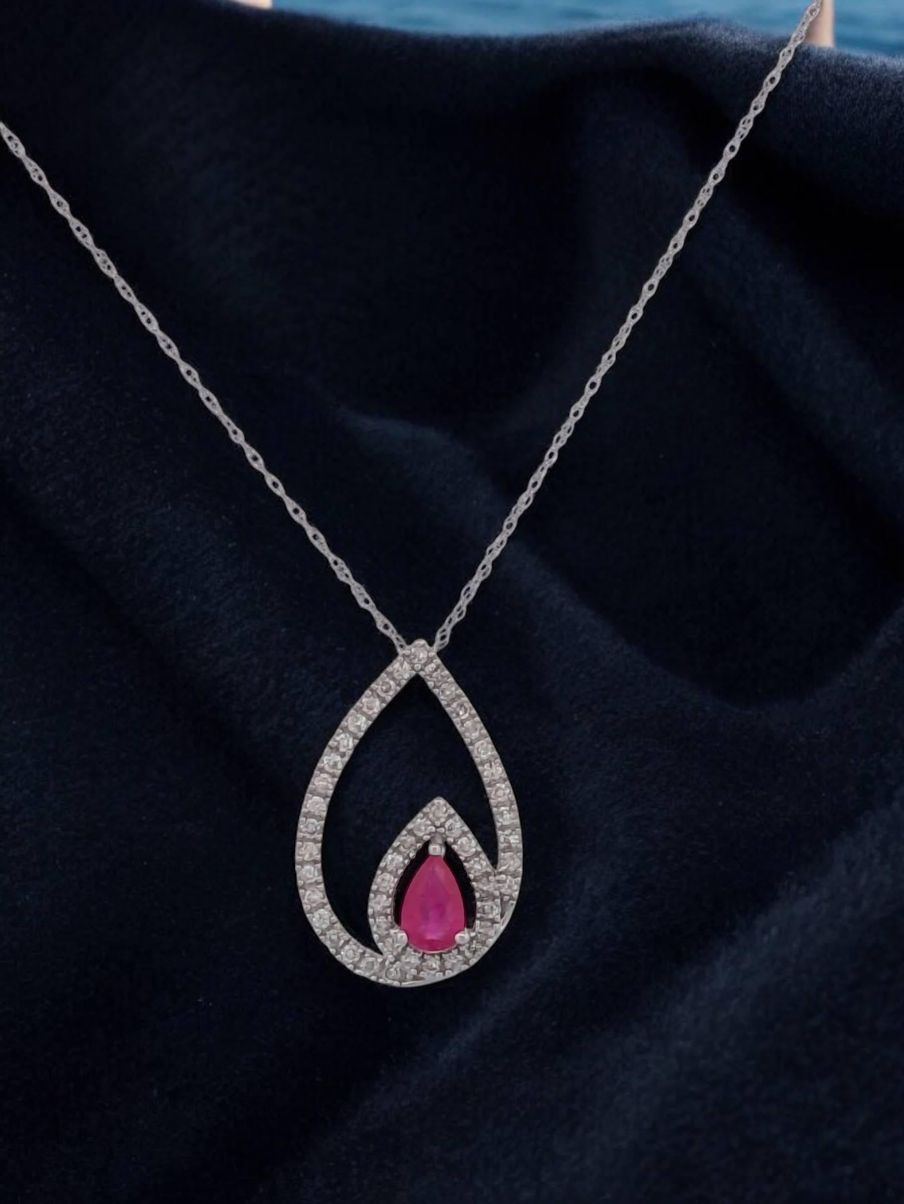 Elevate your style with this 14k White Gold Ruby and Diamond Necklace, designed for timeless elegance and modern sophistication. This luxurious piece combines the captivating allure of a pear-shaped ruby with sparkling diamonds, creating a stunning