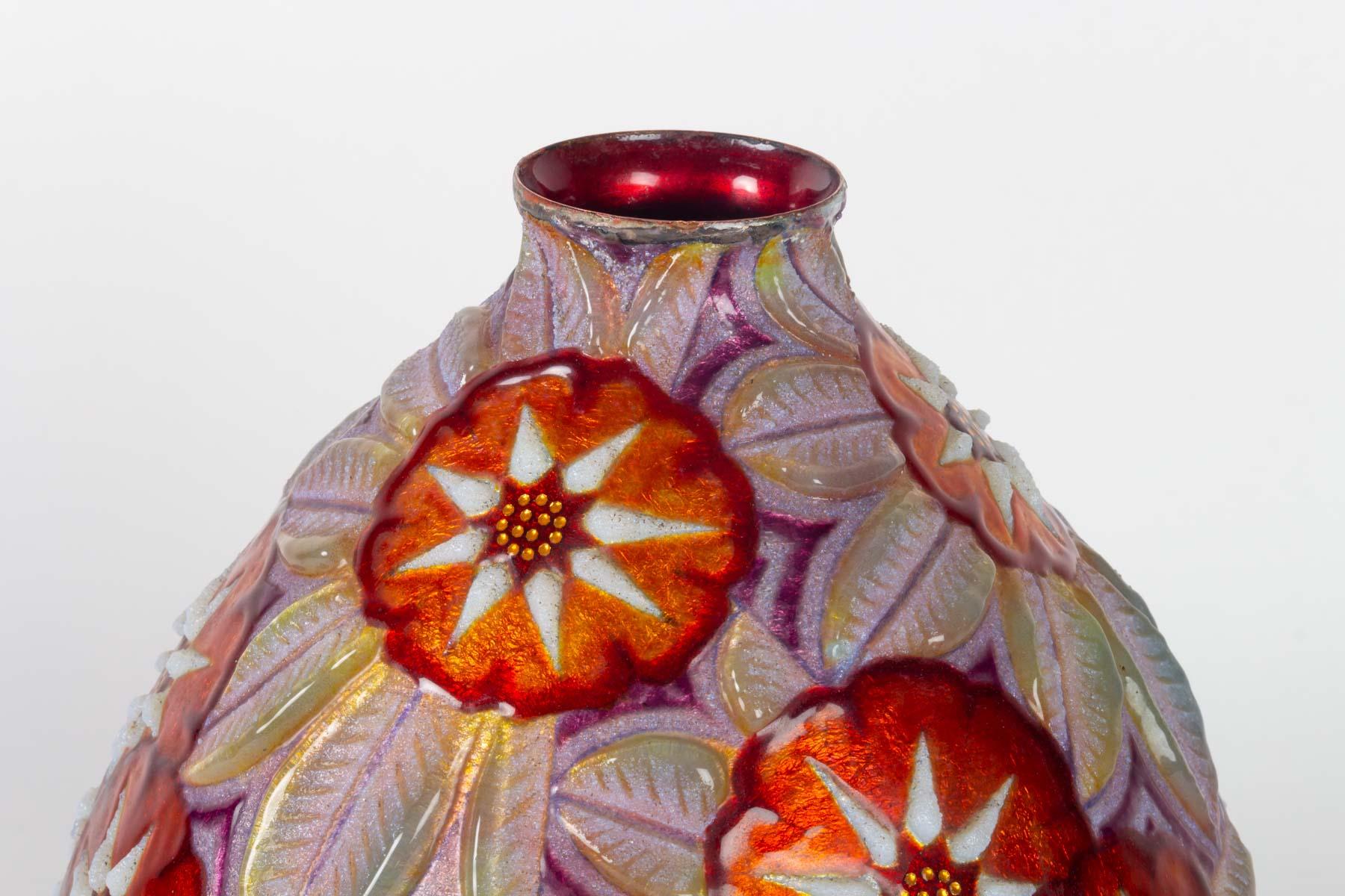 Camille Fauré enameled copper vase: Rare and important ovoid vase with narrow neck in copper decorated with polychrome and translucent enamel. Signed on the base C. Faure. Limoges: small neck strangled and slightly flared.
Copper proof with a rich