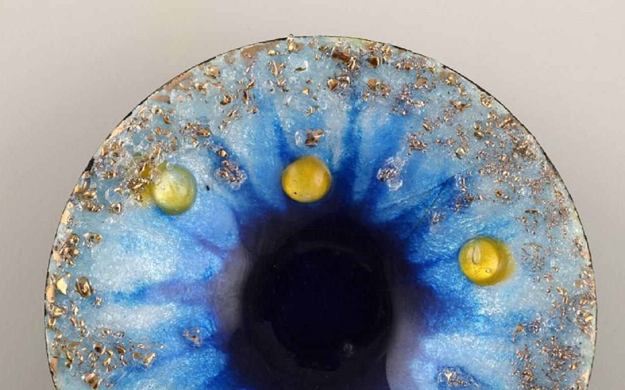 Camille Fauré for Limoges, France. Art Nouveau bronze bowl in enamel work. 
Yellow art glass stones inlaid on blue background. 
Ca. 1910.
An excellent Art Nouveau item of superb quality.
Signed.
In excellent condition.
Measures: 8 x 1.5