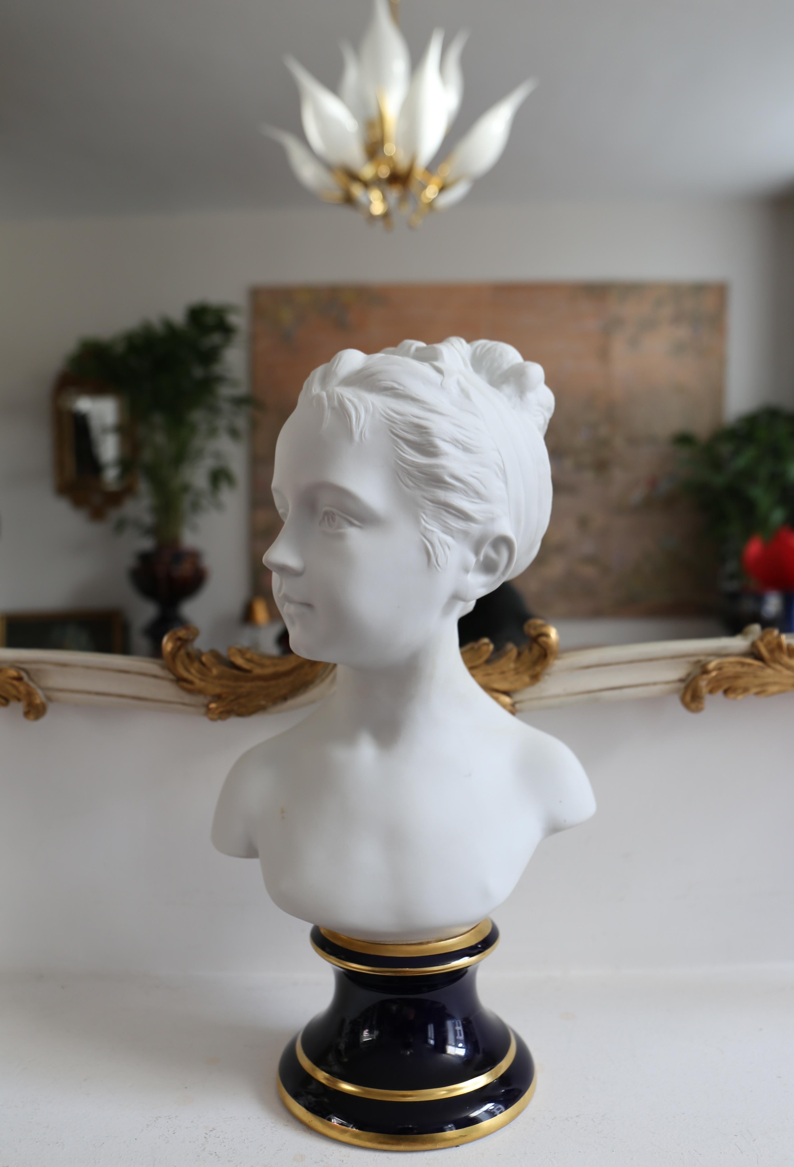 Gorgeous porcelain busts of Louise Brongniart in bisque porcelain on royal blue enameled base, by Tharaud, Limoges, after the originals by Jean-Antoine Houdon (1741-1828). Louise was the child of the architect Alexandre Théodore Brongniart