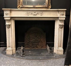 Cheminée en marbre blanc de Carrare, sculptée de motifs végétaux et de pièces de monnaie