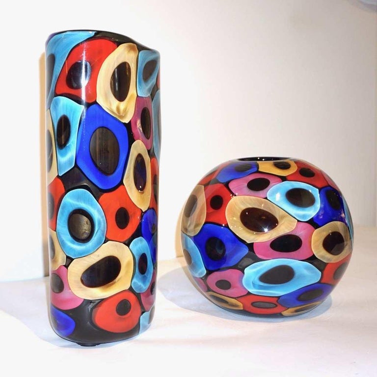 A very decorative organic vase, Work of art signed Camozzo; the interior presents a high quality blown black murano glass with a perfect enamel like finish, overlaid with a post-modern decor like an abstract painting of Murrine in yellow, red, pink,
