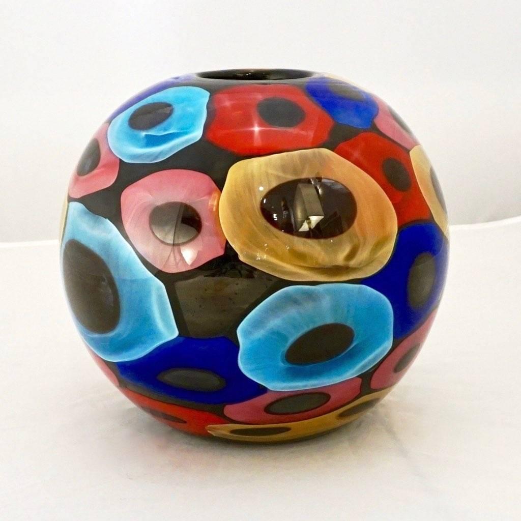 A very decorative organic vase, Work of Art signed Camozzo; the interior presents a high quality blown black Murano glass with a perfect enamel like finish, overlaid with a post-modern decor like an abstract painting of Murrine in yellow, red, pink,