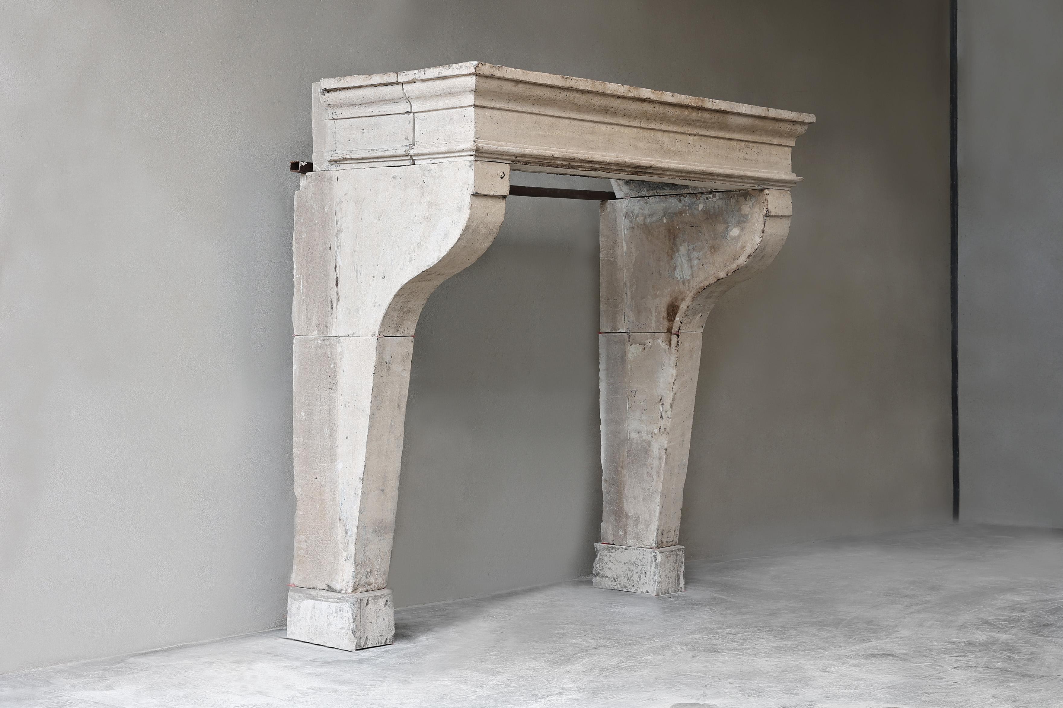 The antique French limestone fireplace from the 19th century exudes the rustic charm of the countryside. A fireplace with beautiful lines and rural appearance with a very accessible size that can be used in many interiors. This mantel adds value to