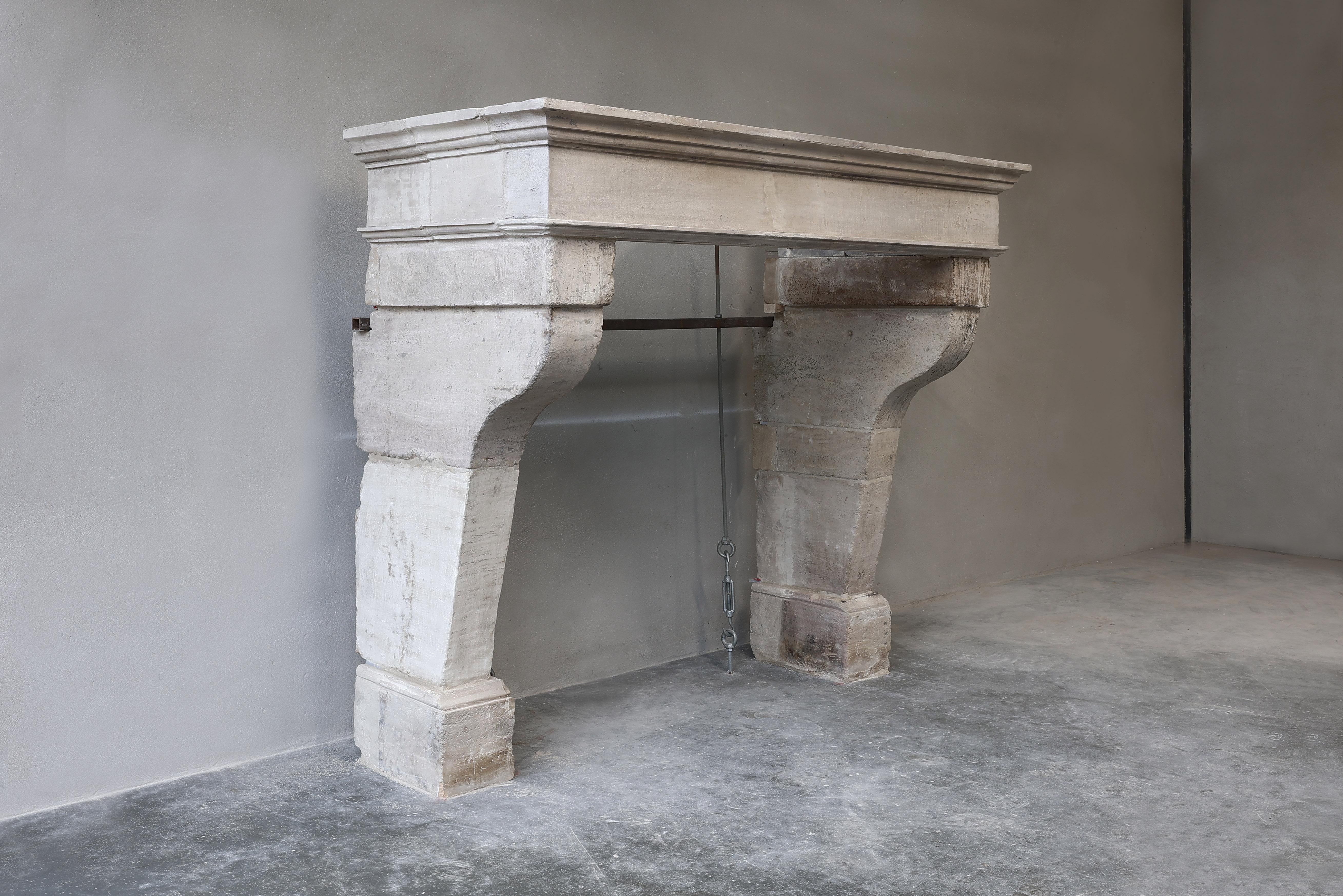 Beautiful rustic antique fireplace of 19th century French limestone. This chimney has a nice size, which makes it look good in many interiors. The rural appearance and moldings give the fireplace even more allure!
