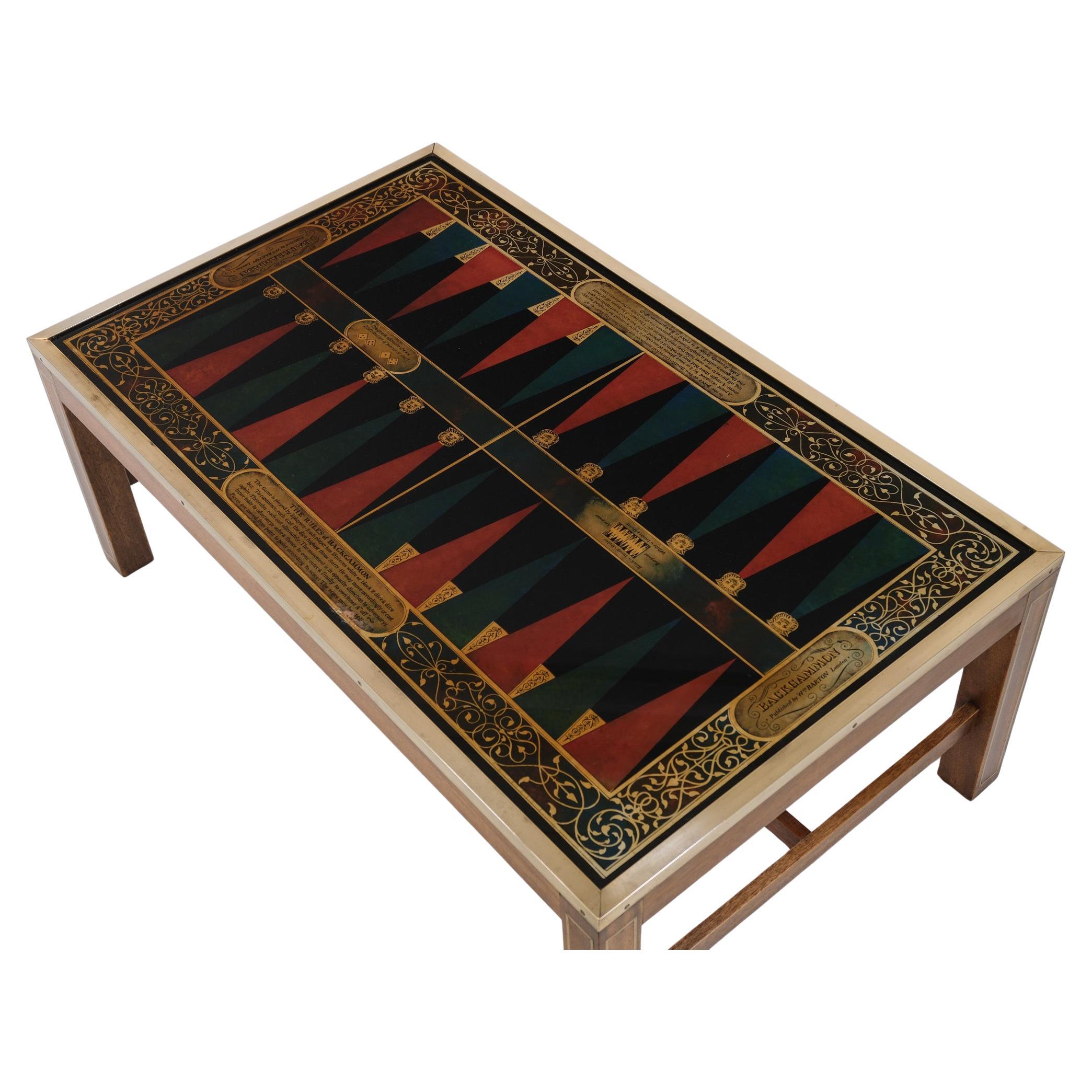 Wonderful campaign antique style coffee table with a backgammon inset, published by William Barton, London, England - Circa 1950-60.

This interesting coffee table is made in solid wood with brass inlay to the legs and brass edging to the top. It is