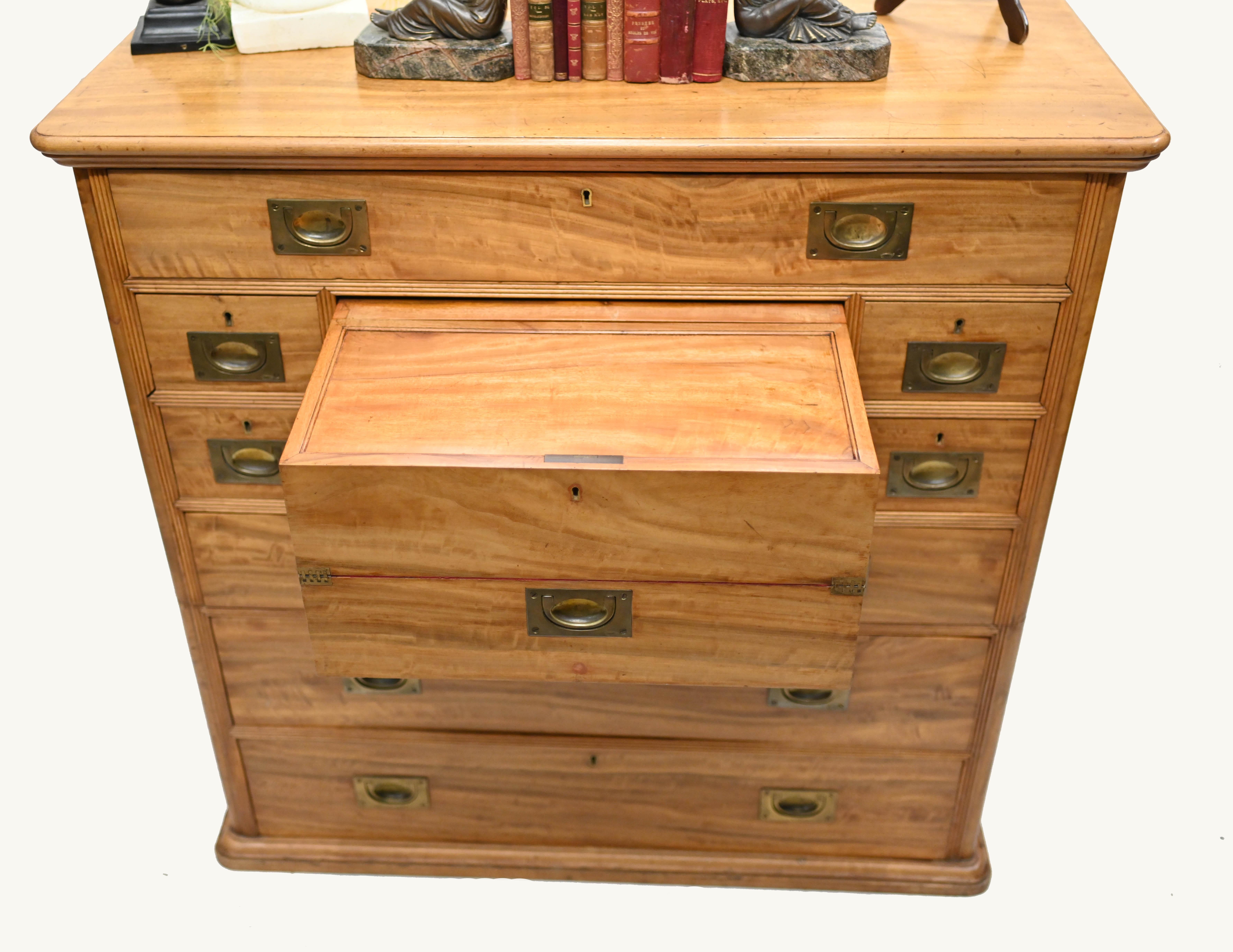 You are viewing a highly sought after antique campaign chest / secretary
The piece has been crafted from camphor wood and is circa 1910
The central section opens out to reveal the red felt finished writing surface
Around this are mini drawers and
