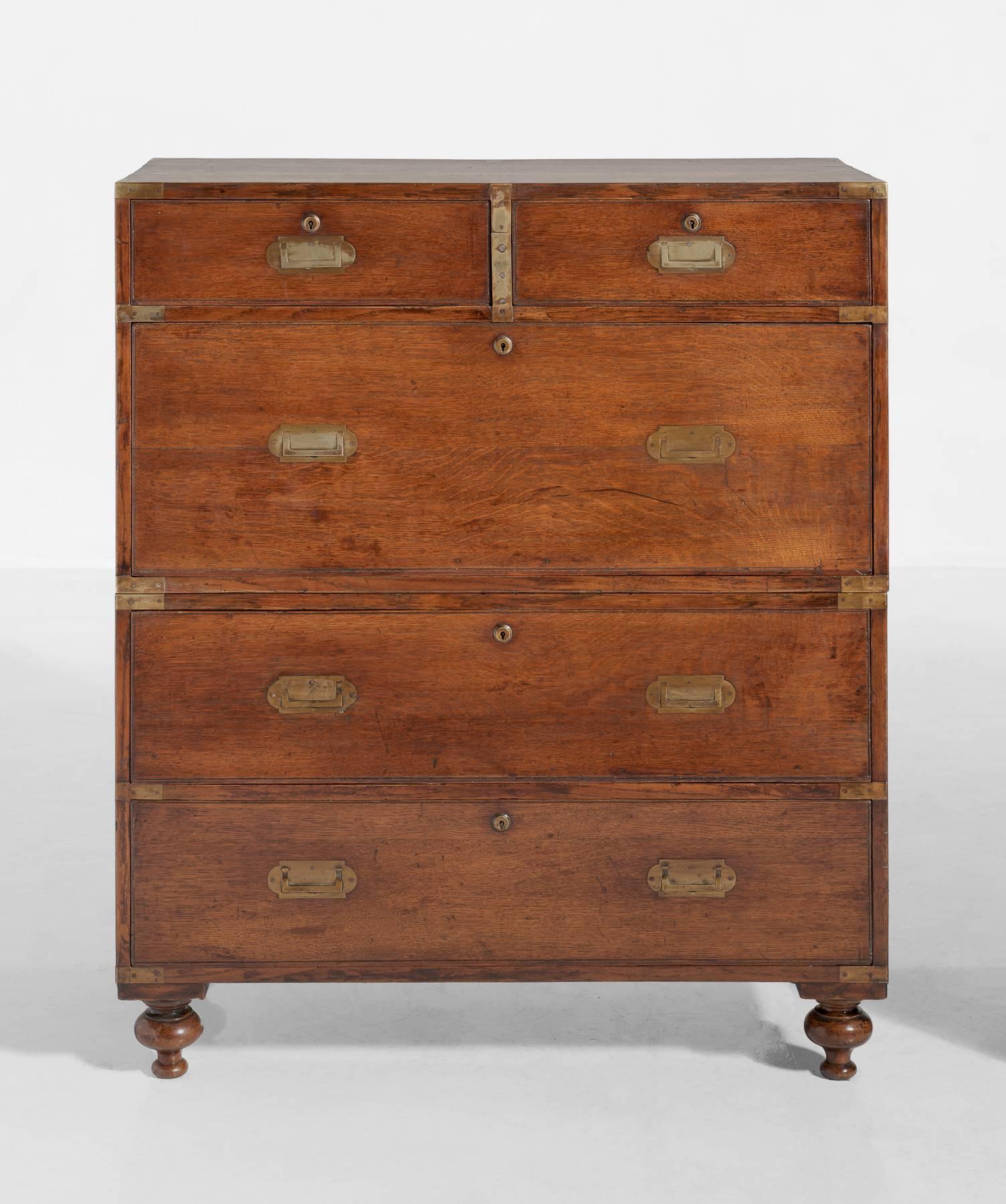 Campaign chest of drawers, England, circa 1910.

Unique oak chest with original brass mounts and hardware.