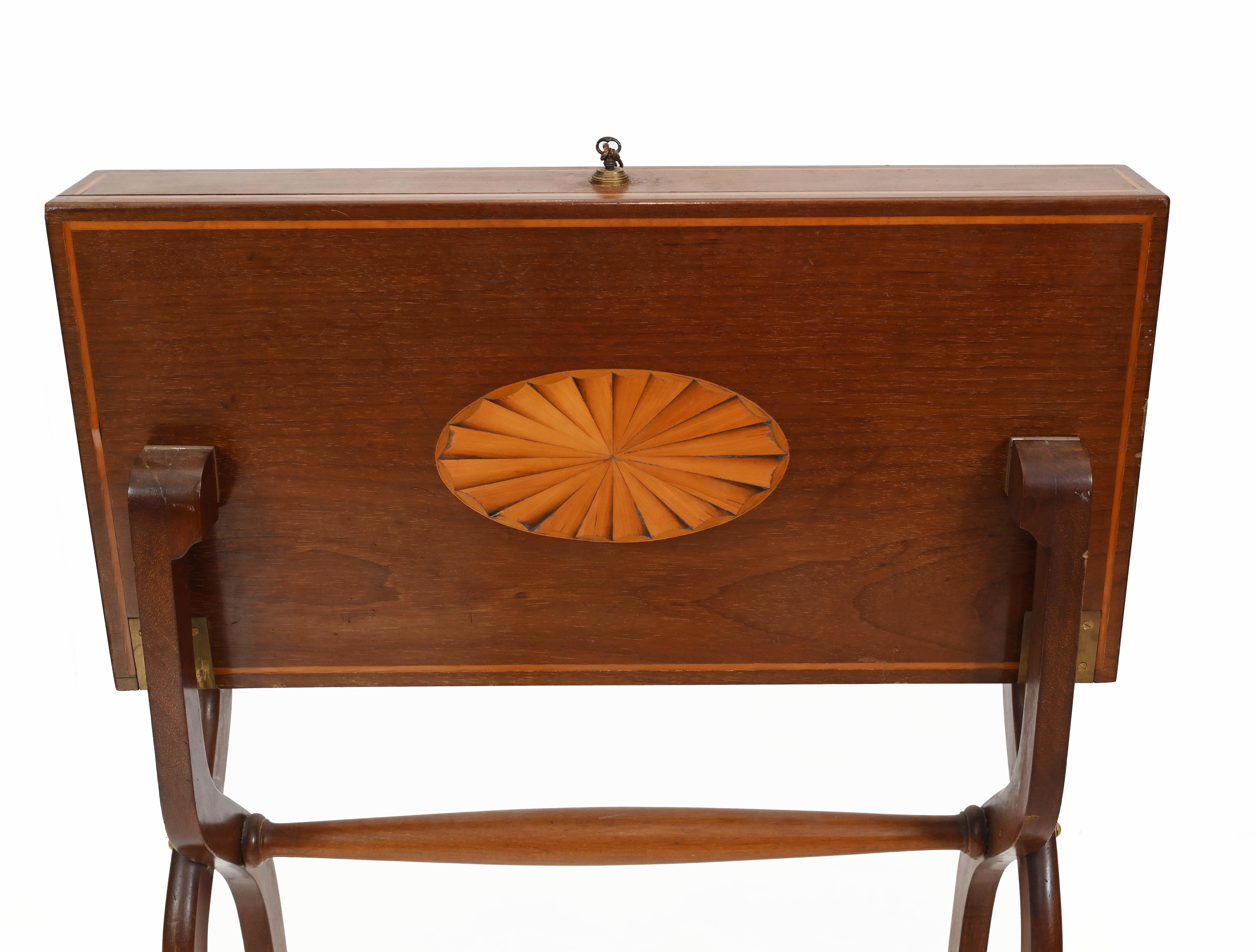 Rare Edwardian travelling or campaign desk in mahogany 
Desk stands upright when closed or folded up with almond shaped shell inlay motif
Desk opens out to reveal writing surface surrounded by leather
Piece comes with original accessories like