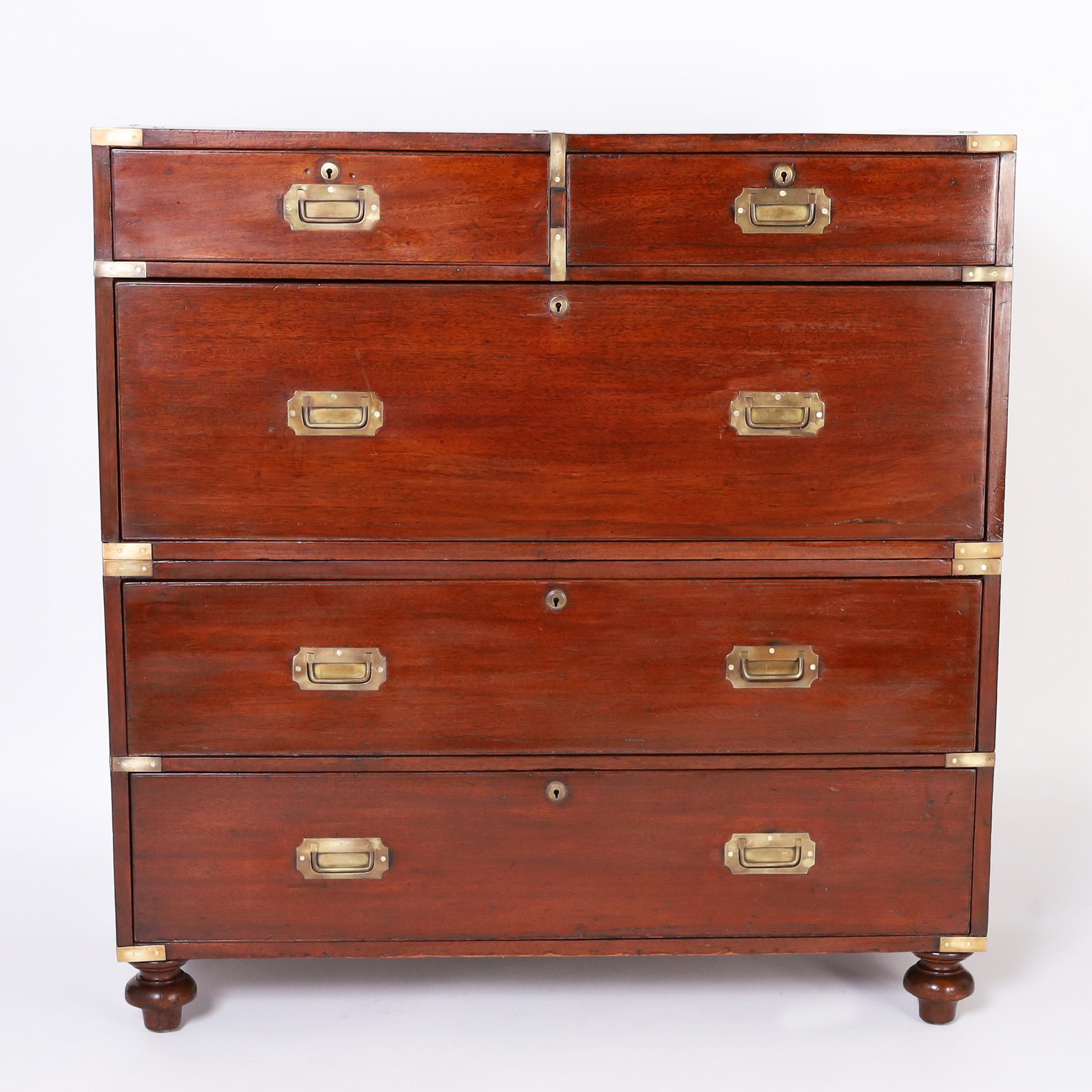Handsome 19th century British colonial campaign chest hand crafted in mahogany with classic two piece construction, five drawers, brass hardware, and turned feet.