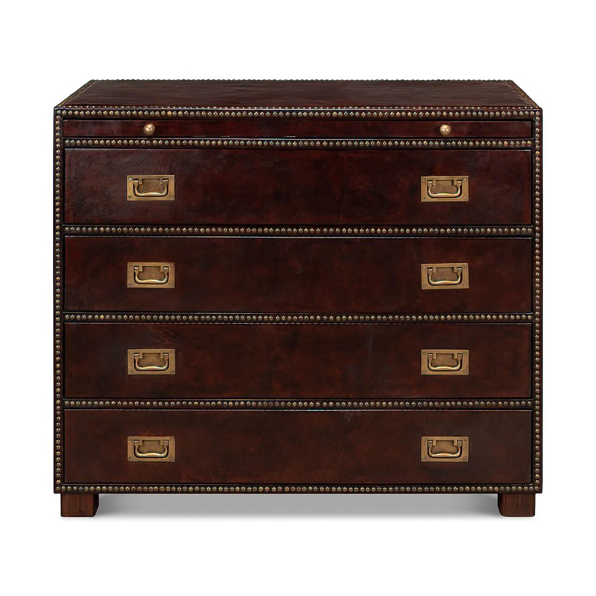 A Campaign style dresser with antique brown leather-wrapped sides. With four drawers and a slide, brass handles, and nailhead details all around the frame. 

Dimensions
40