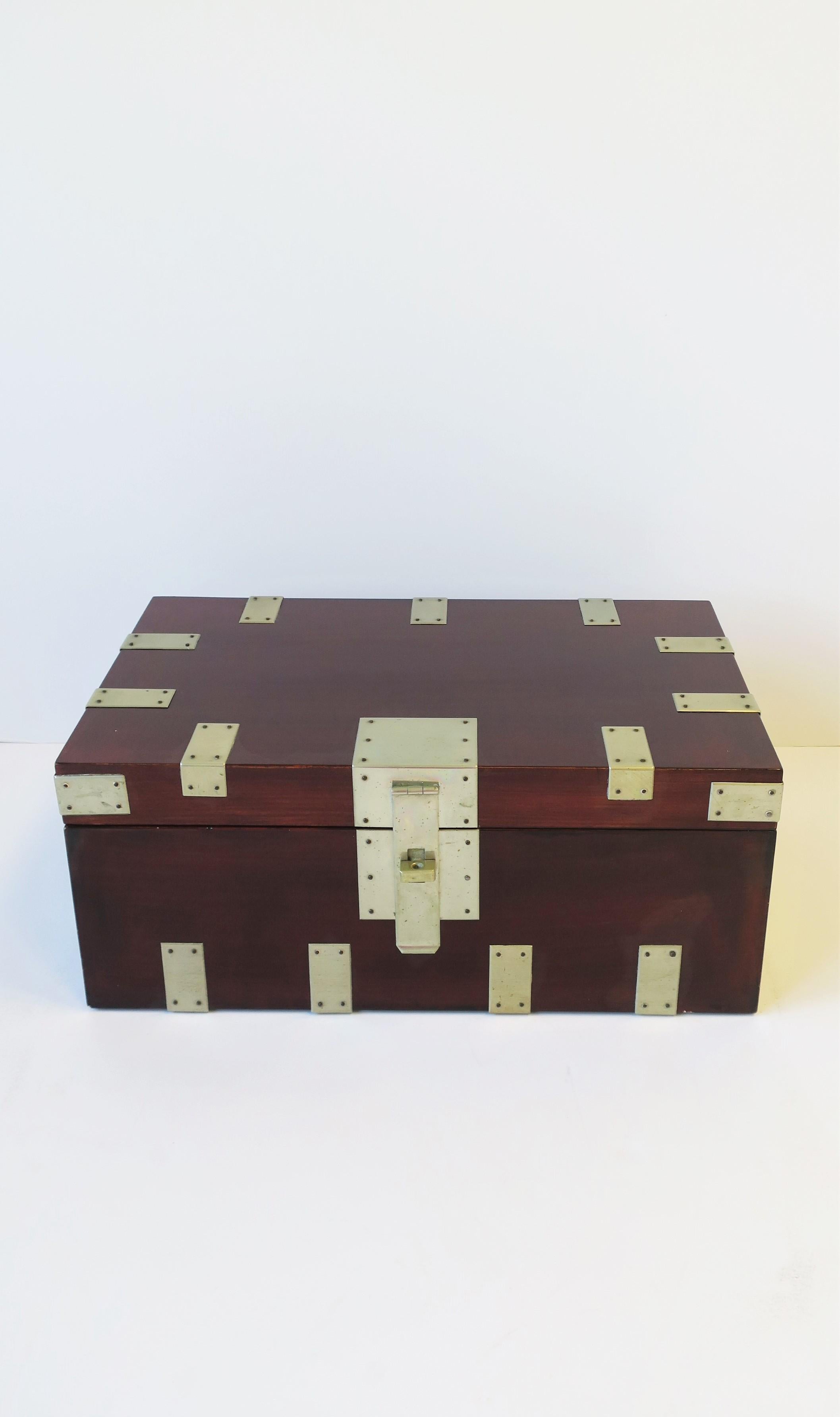 A relatively large rich dark red burgundy lacquer storage chest box with metal detail by designer Rae Kasian, circa late-20th century, 1980s, 1990s. Box is red burgundy lacquer with rectangular silver metal and small brass nail detail around,
