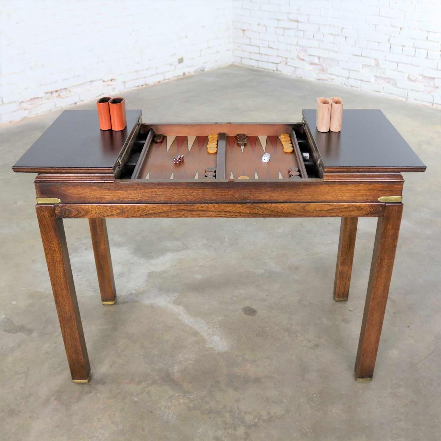 Handsome Campaign style combination console table, sofa table, backgammon game table with flip open top by Lane Furniture. Its style number is 920 62 and it is in wonderful vintage condition with no outstanding flaws. Marked on the bottom with