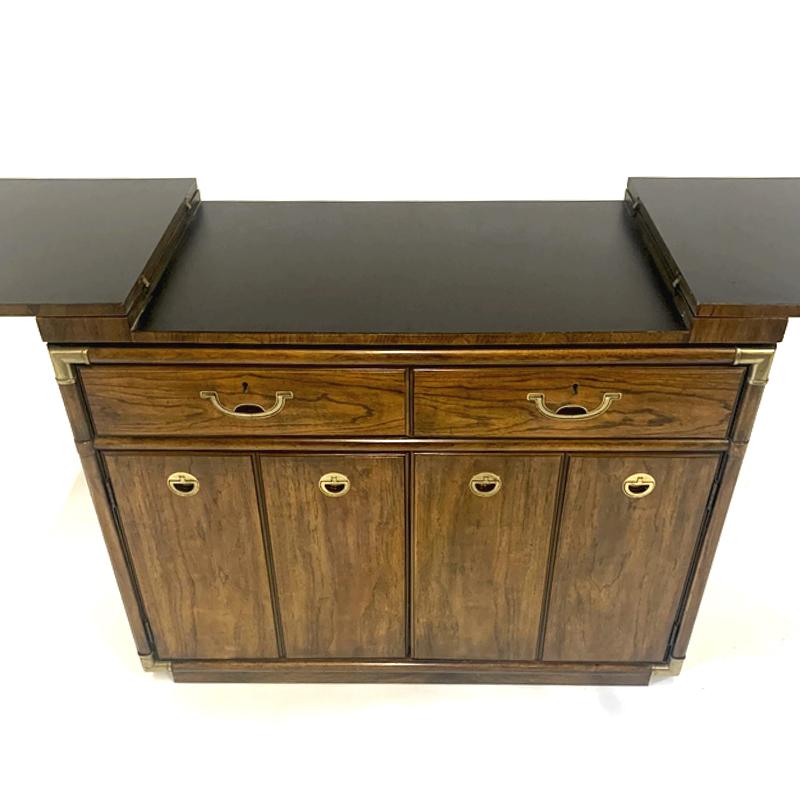 Very functional bar chest or cabinet. Decorative wood cabinet with brass detail and handles. This piece is on wheels so can be moved easily to use as an actual service bar or buffet / server for parties. This is a great multifunctional