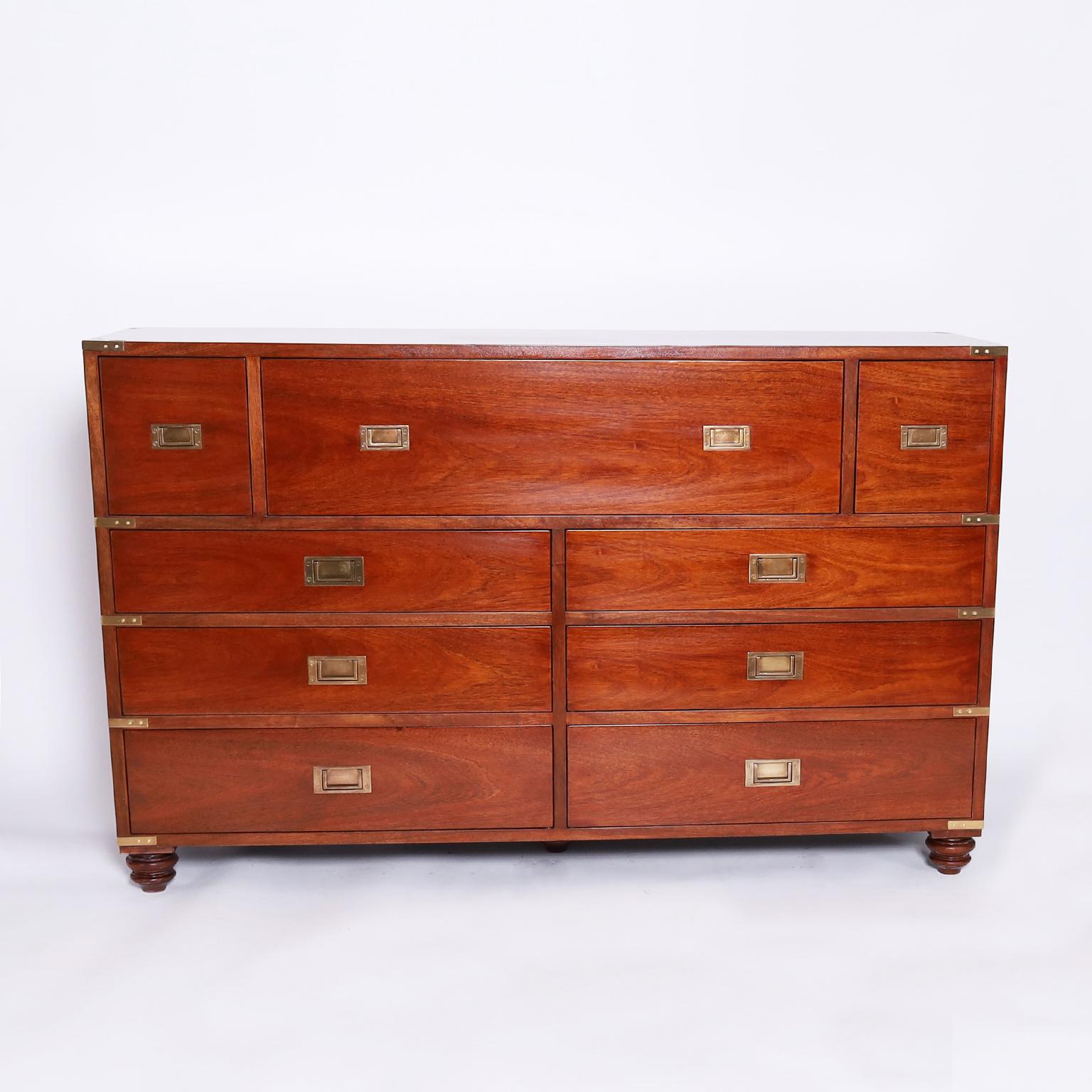 Handsome British Colonial style chest with nine drawers crafted in well grained mahogany with brass campaign hardware and turned feet. Signed Lauren by Ralph Lauren on a brass plaque.