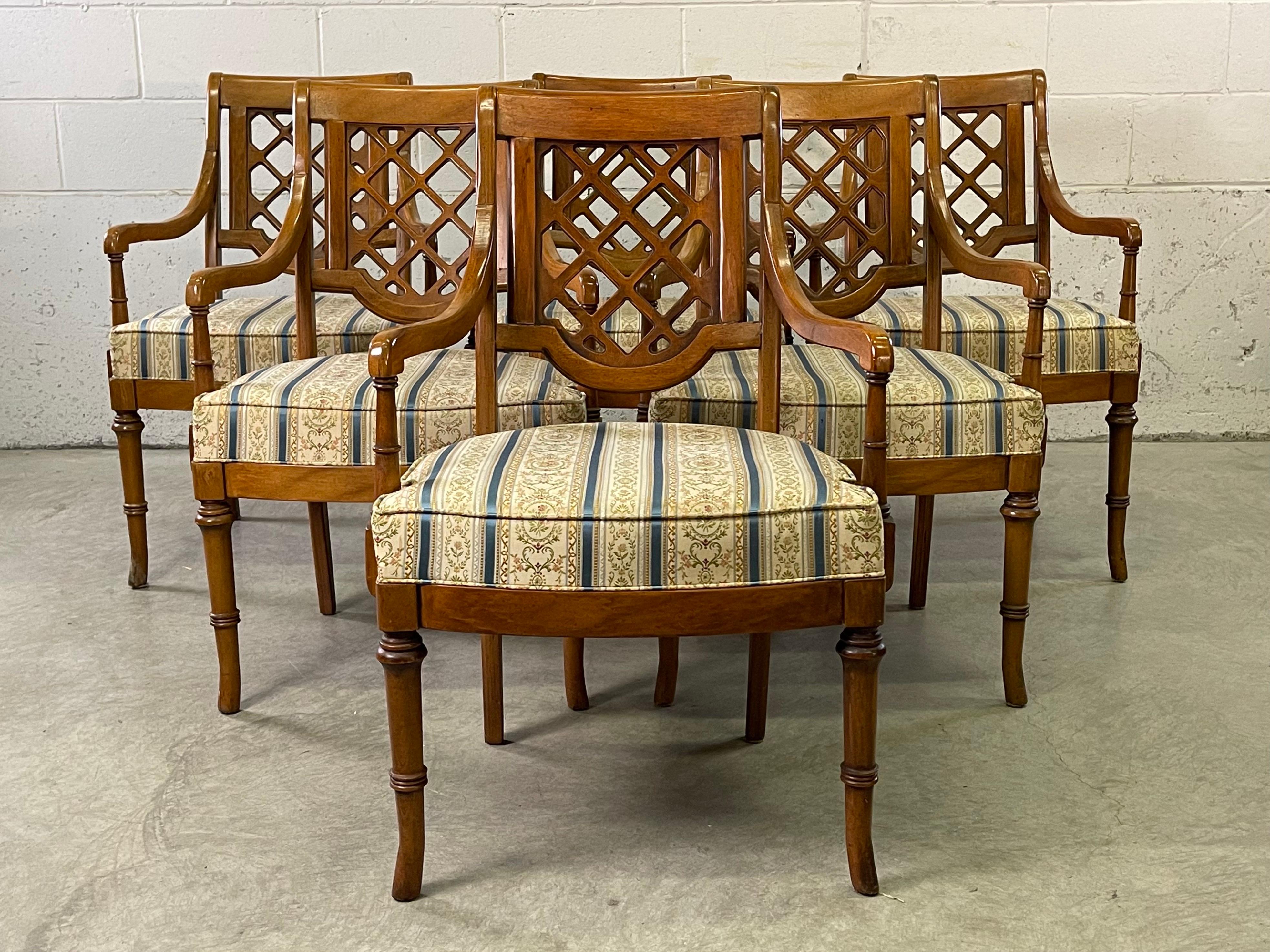 Vintage 1960s set of six campaign style dining room arm chairs with fabric seats. The chairs have a lattice back design. The chairs are all solid and sturdy, these are heavy chairs. No marks. Arms, 24.5