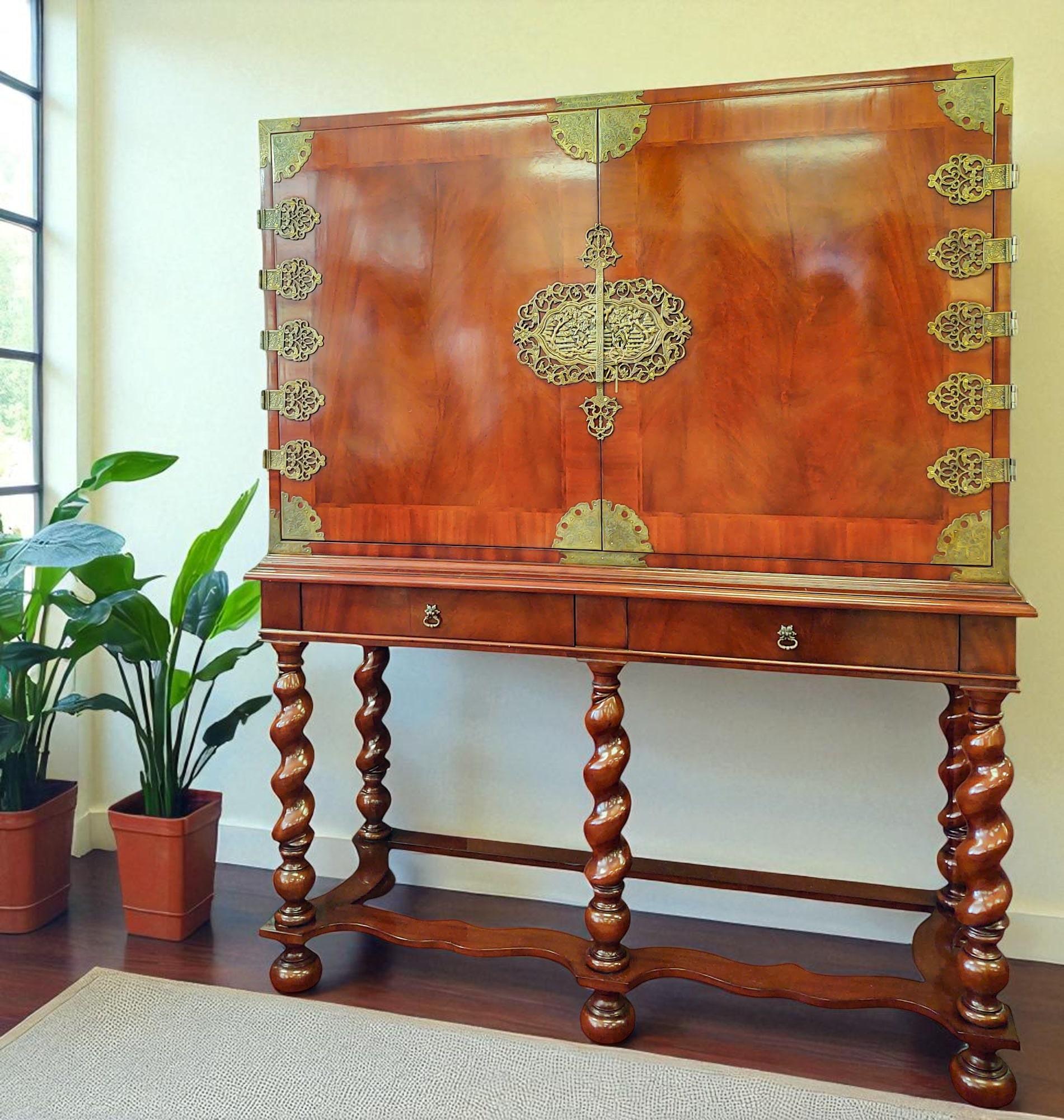A striking cocktail cabinet by Jansen, the Dutch design firm founded in 1981 by Andries Jansen and Fredrick Janssen. This distinctive piece fuses Chinoiserie and Anglo-Indian influences, featuring a rich high-gloss finish accented with intricate